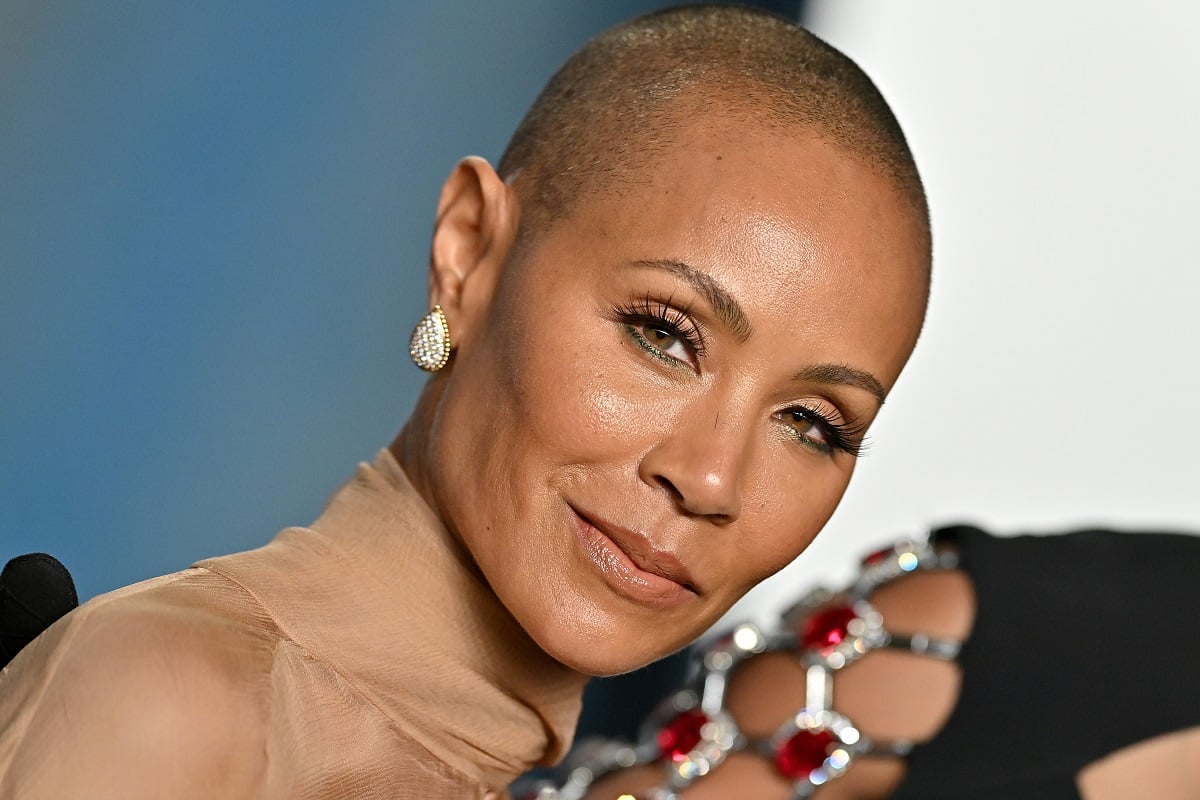 Jada Pinkett Smith posing while wearing a brown dress.