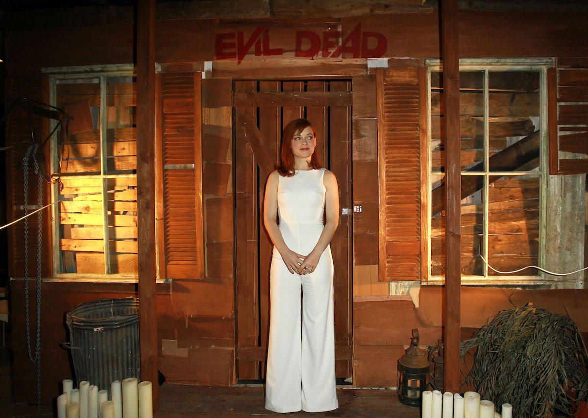 Jane Levy poses in front of the ‘Evil Dead’ cabin