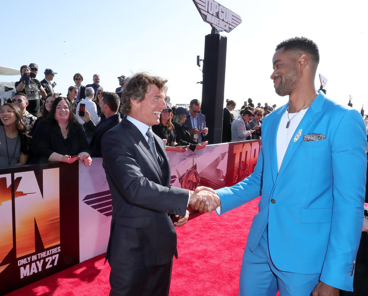 Tom Cruise (left) and Jay Ellis attend May 4, 2022, premiere of "Top Gun: Maverick." Cruise gave Ellis acting advice and words of encouragement while filming.