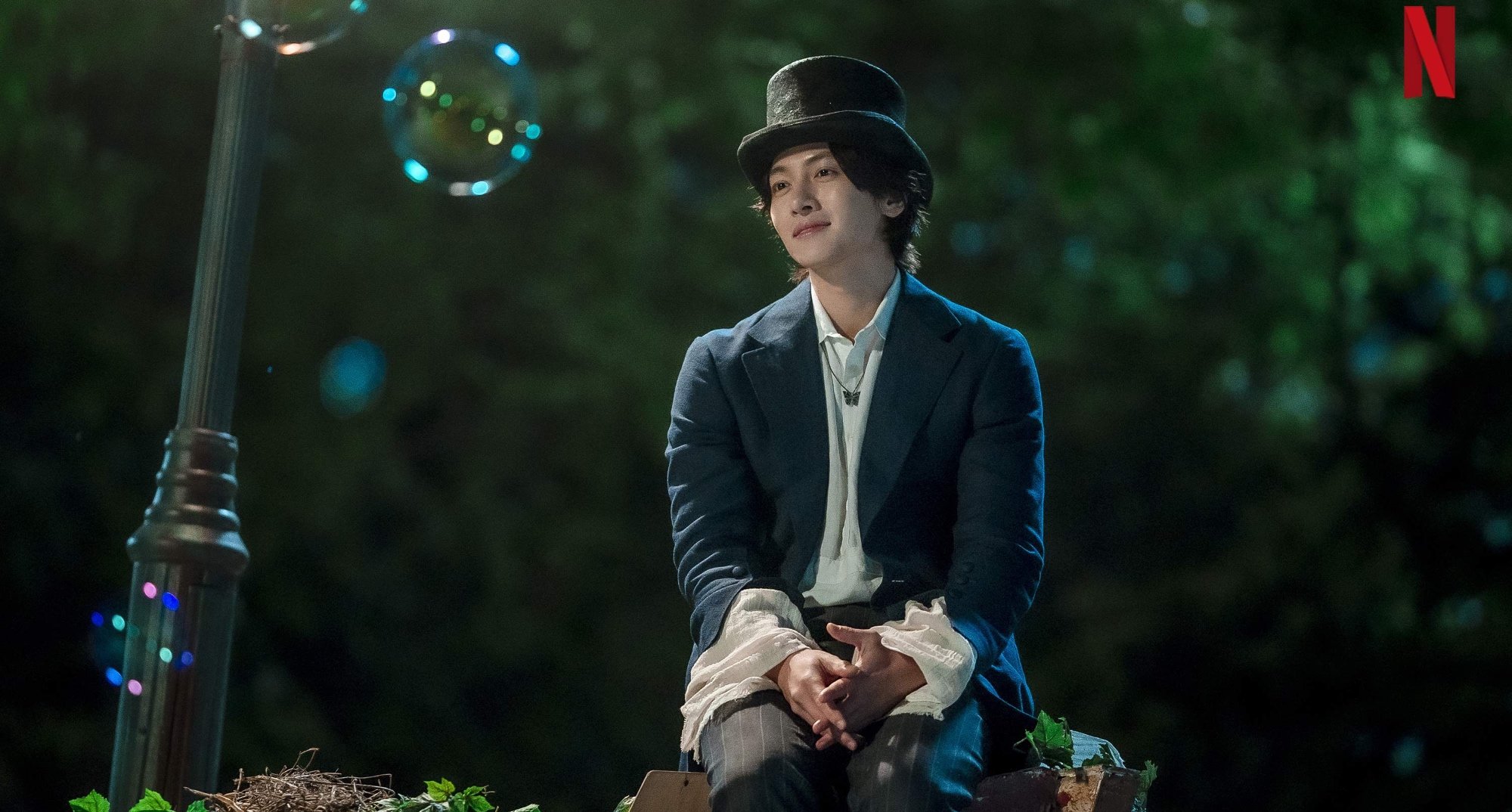 Ji Chang-wook in 'The Sound of Magic' K-drama wearing top hat in amusement park.