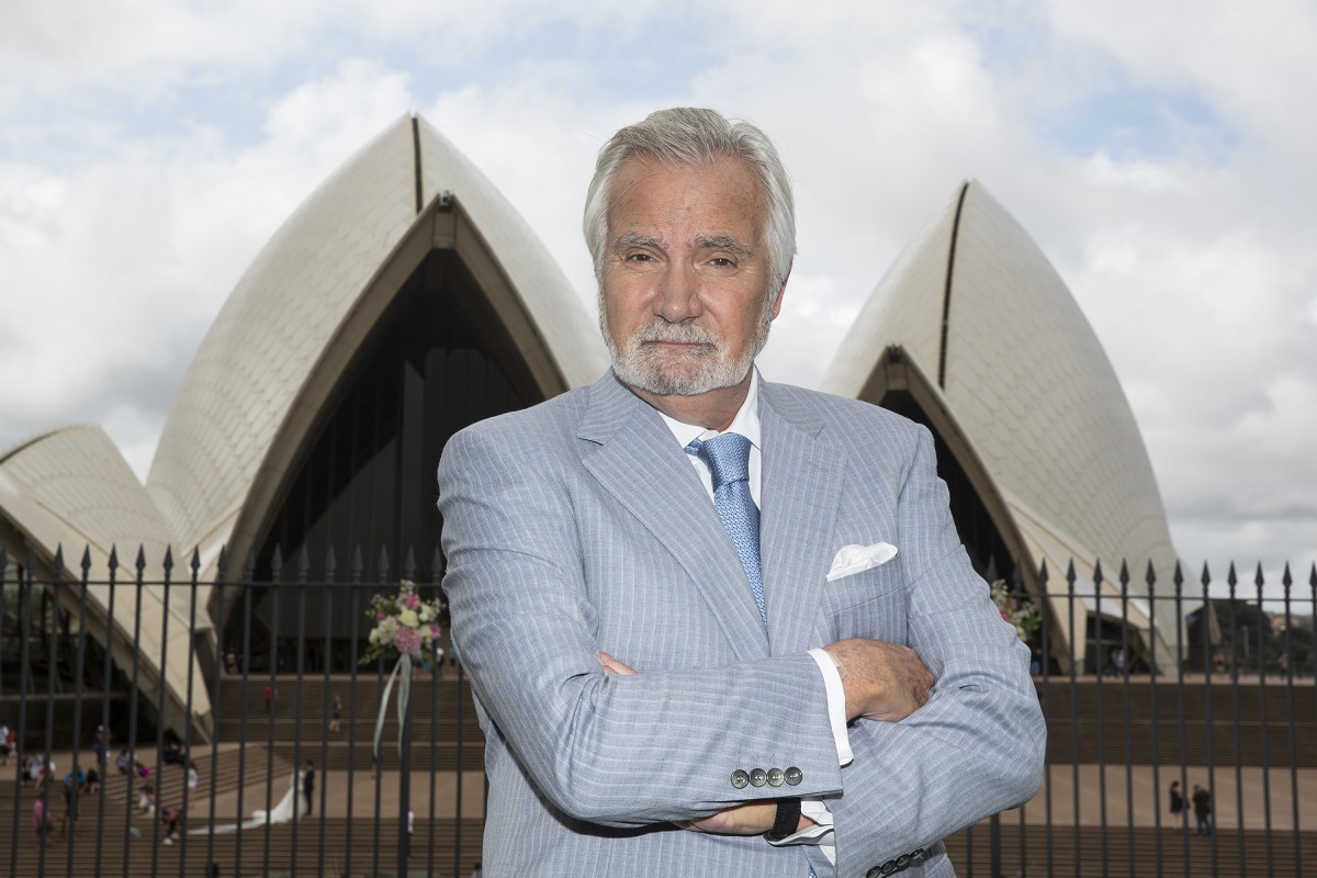 'The Bold and the Beautiful' actor John McCook wearing a blue and white suit while posing in front of the Sydney Opera House.