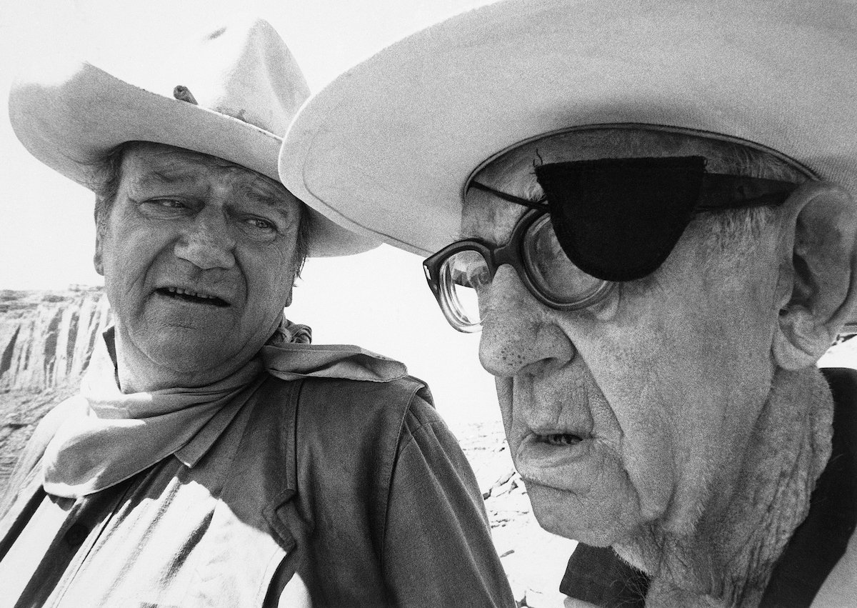 John Wayne sits with his mentor John Ford on the set of a western