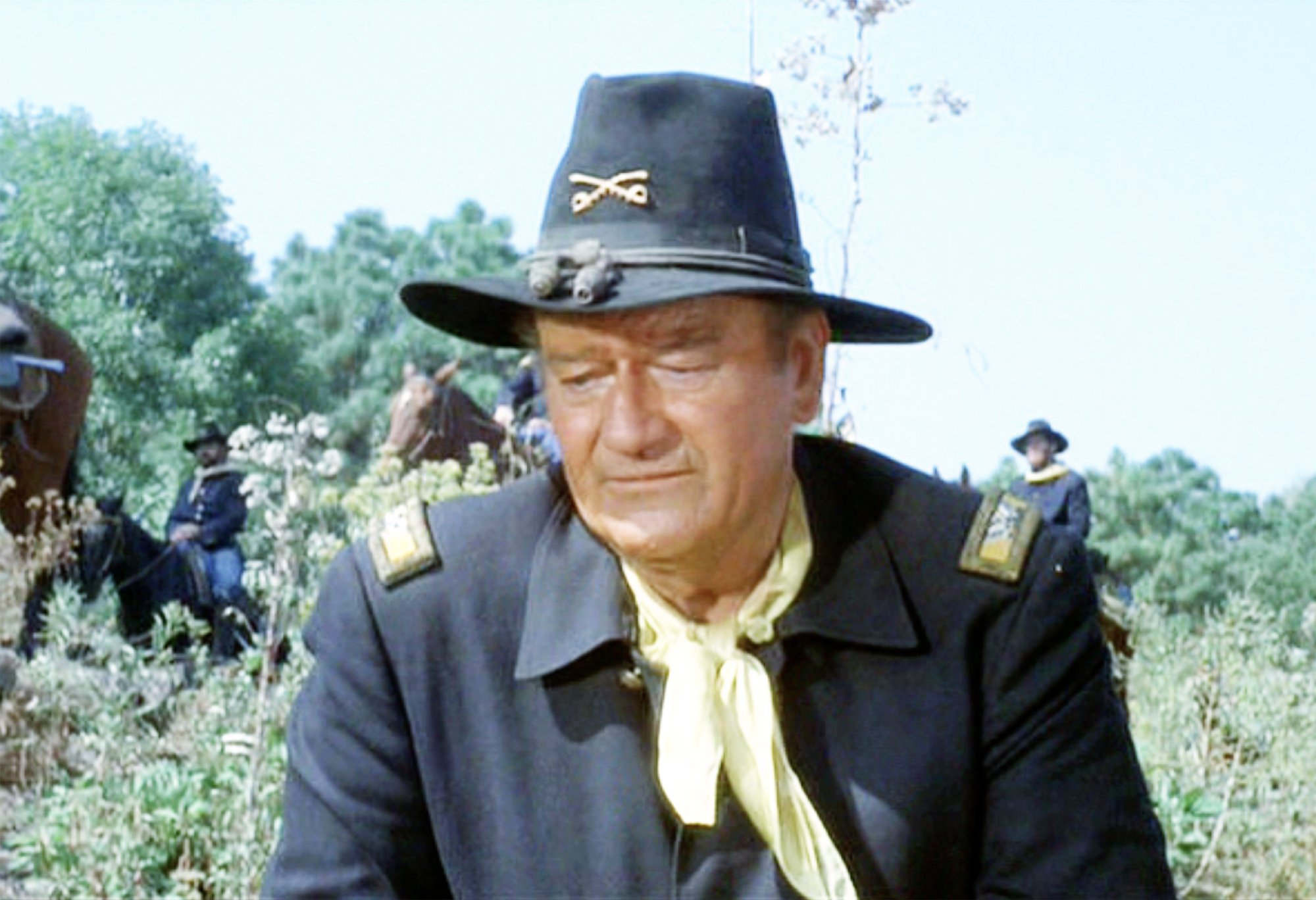 John Wayne as Col. Cord McNally in 'Rio Lobo' in a cowboy outfit looking down at the ground, who's real mom was Mary 'Molly' Alberta Brown