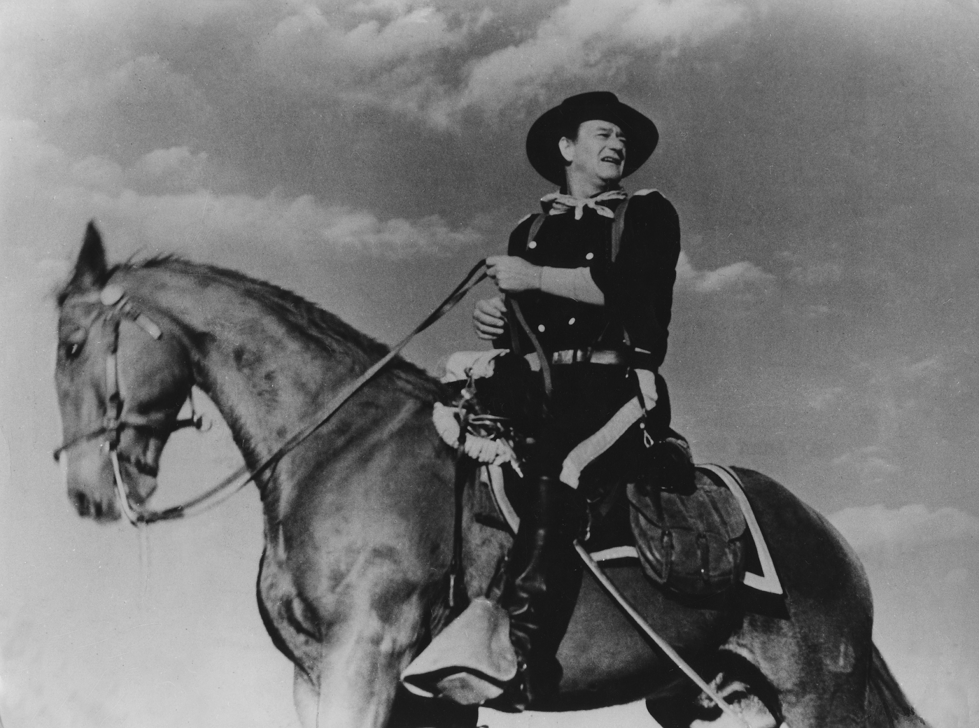 John Wayne in his performance as Col. John Marlowe on horseback looking over his shoulder