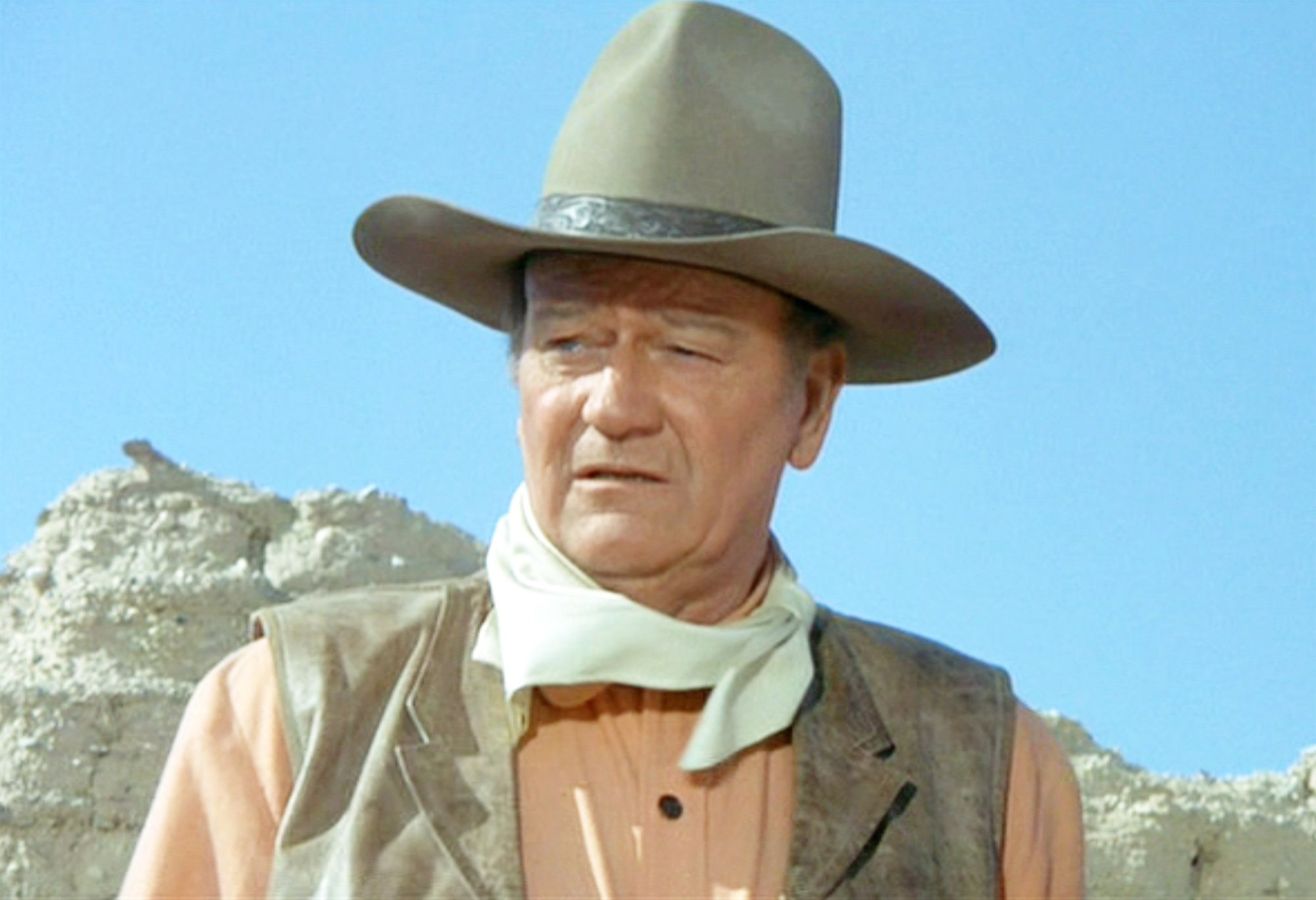 John Wayne wears a cowboy hat, kerchief and the name of his hero
