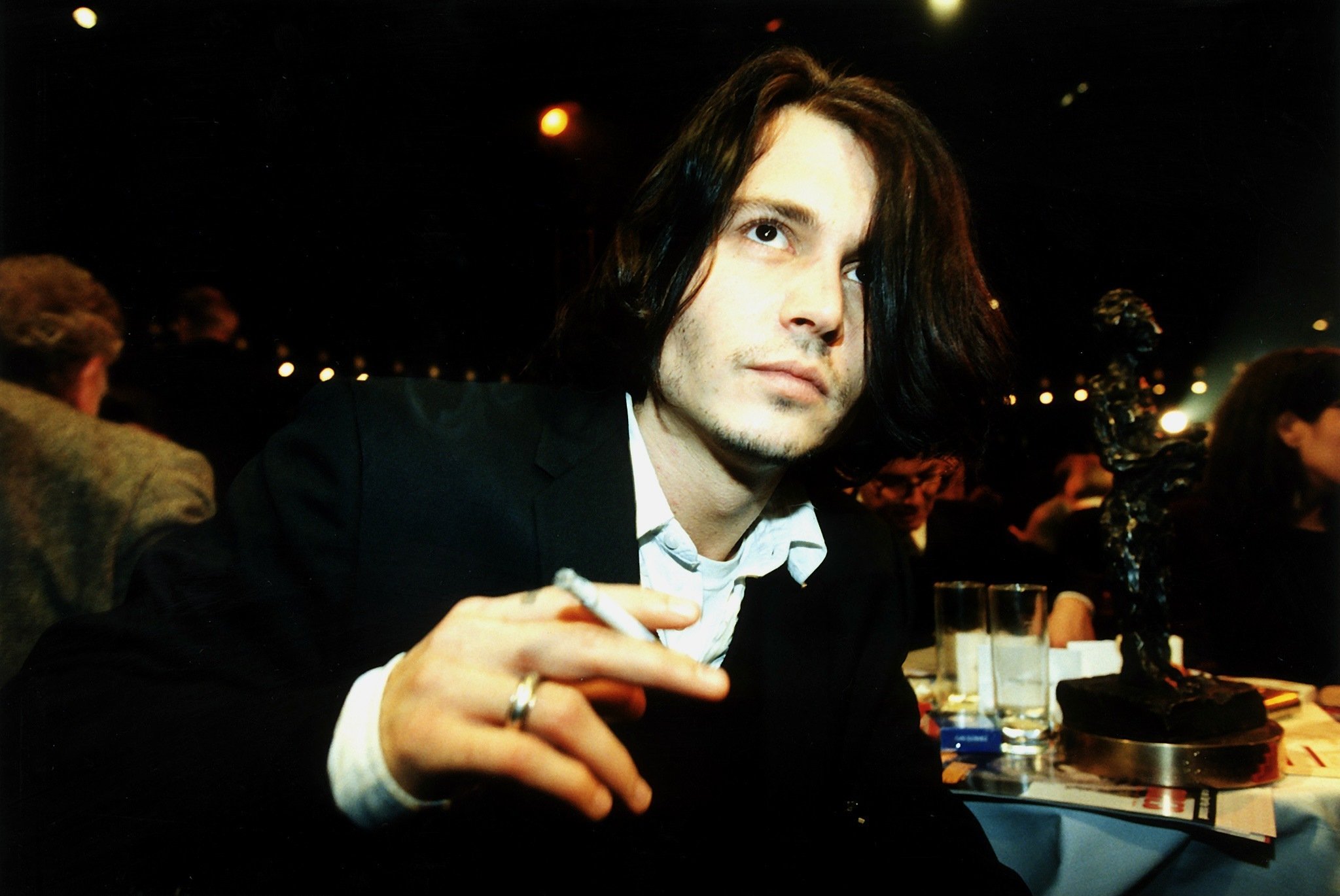 Johnny Depp holds a cigarette in the '90s, when he had several encounters with Jennifer Love Hewitt
