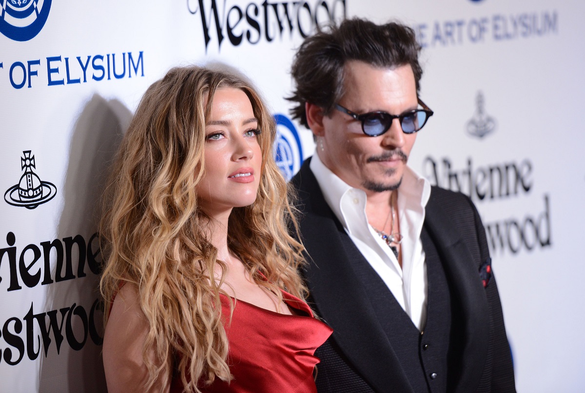 Johnny Depp smiling alongside Amber Heard.