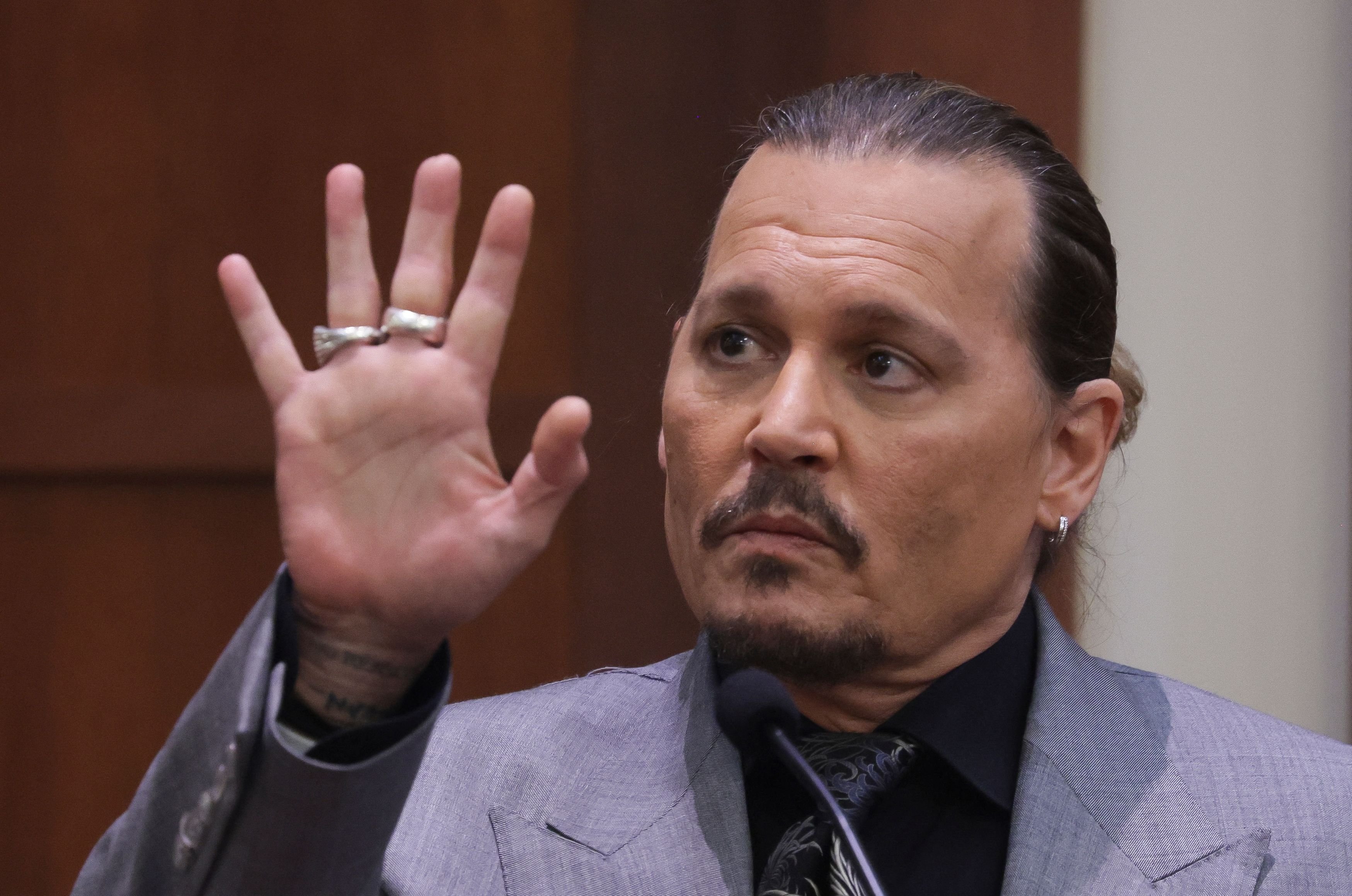 Johnny Depp displays his middle fingertip, which he says he injured while staying at a mansion in Australia with his ex-wife Amber Heard