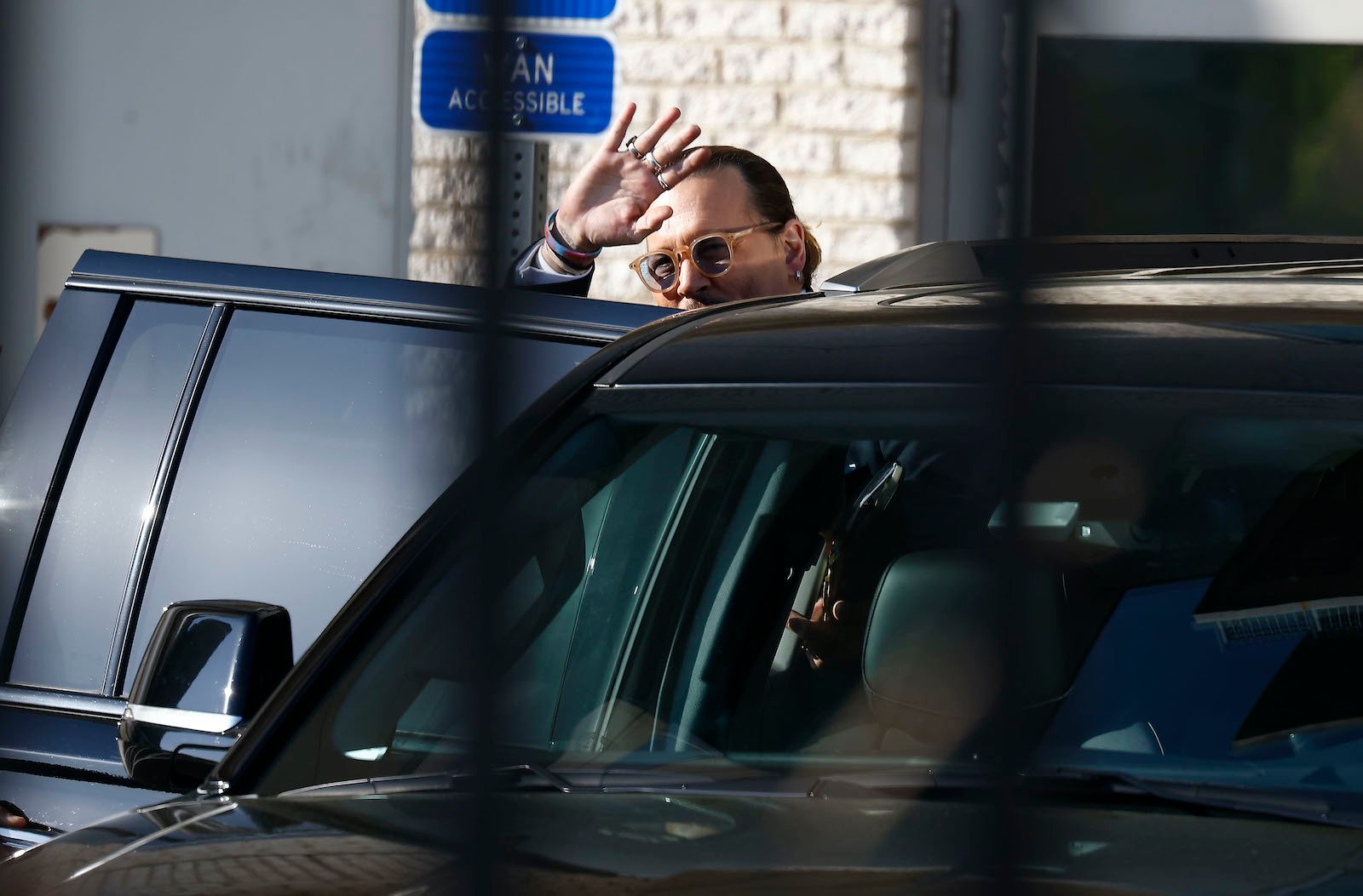 Johnny Depp waves to fans outside court 