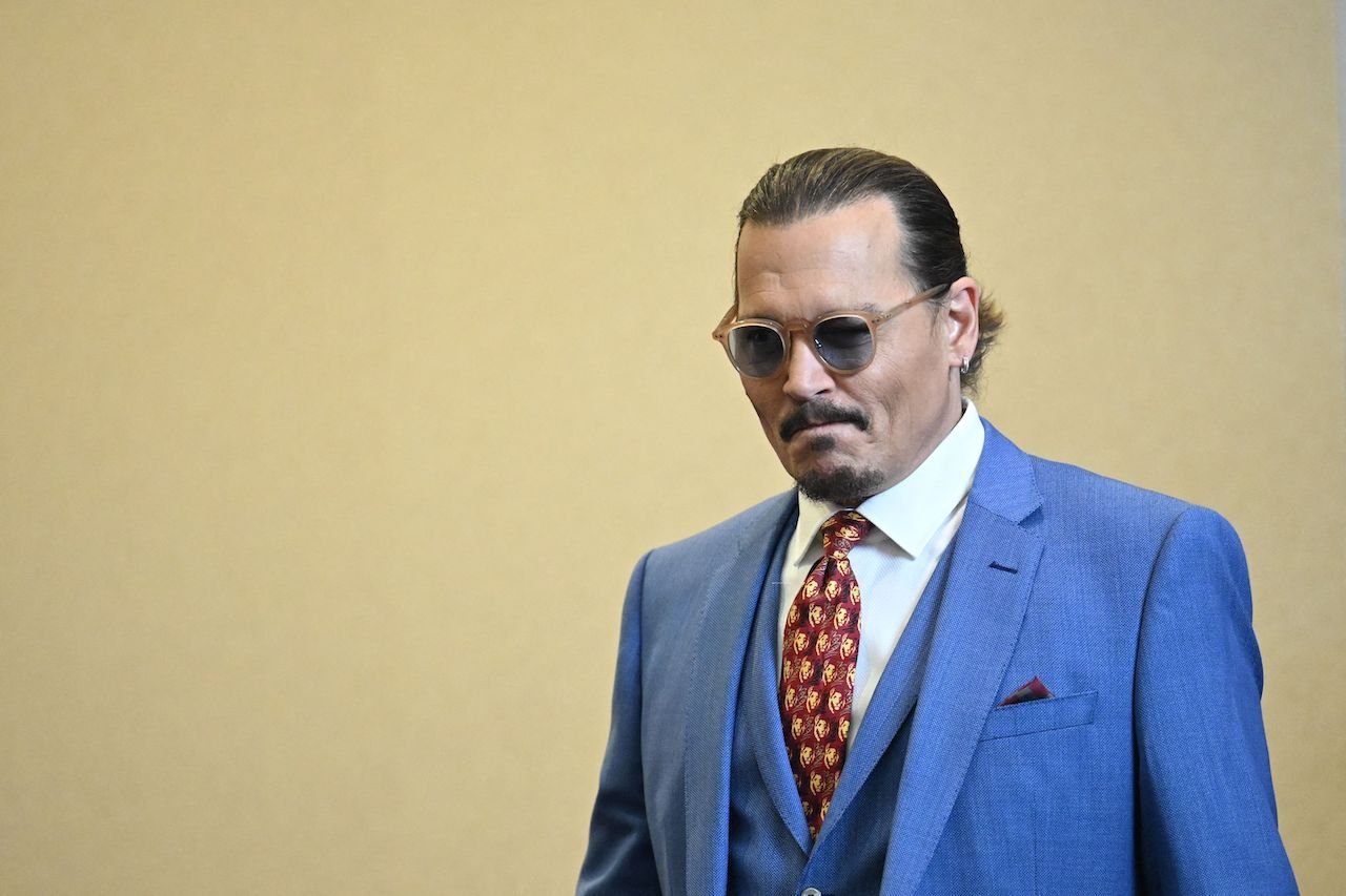 Johnny Depp stands in the courtroom, the same day as a Hicksville witness testified