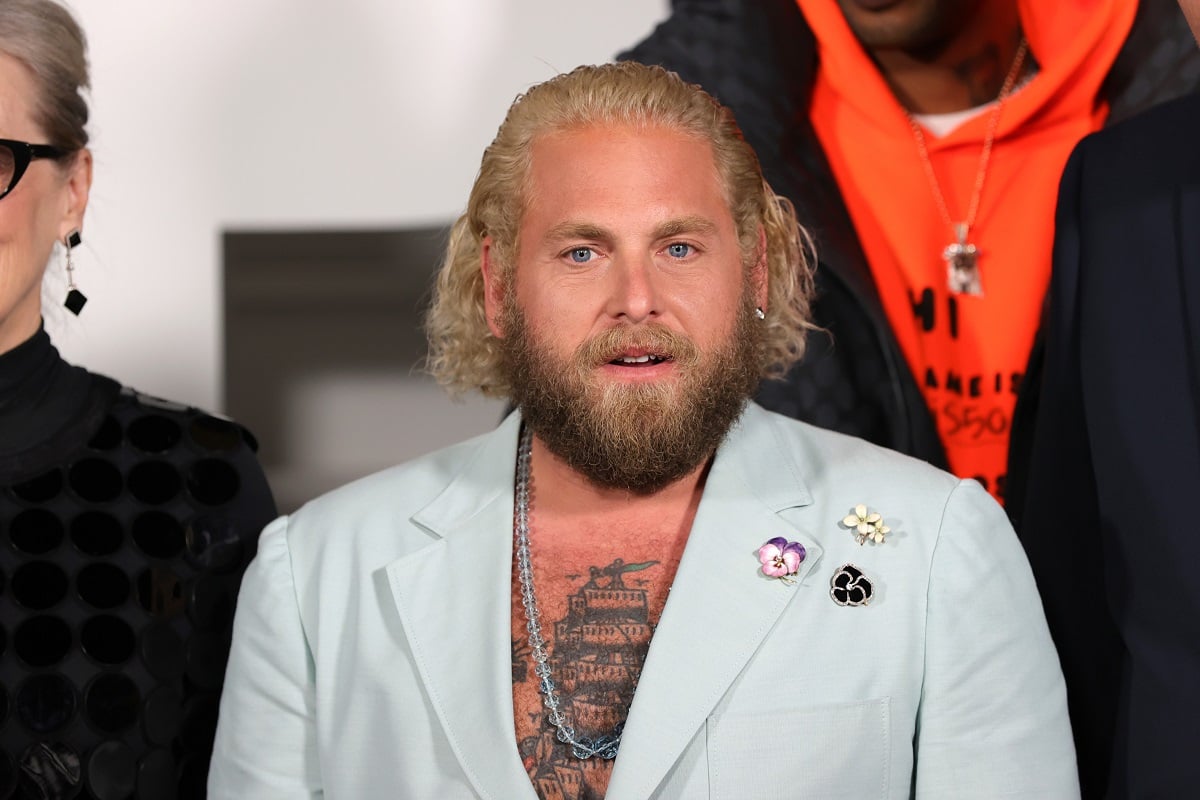 Jonah Hill posing while wearing a blue suit.