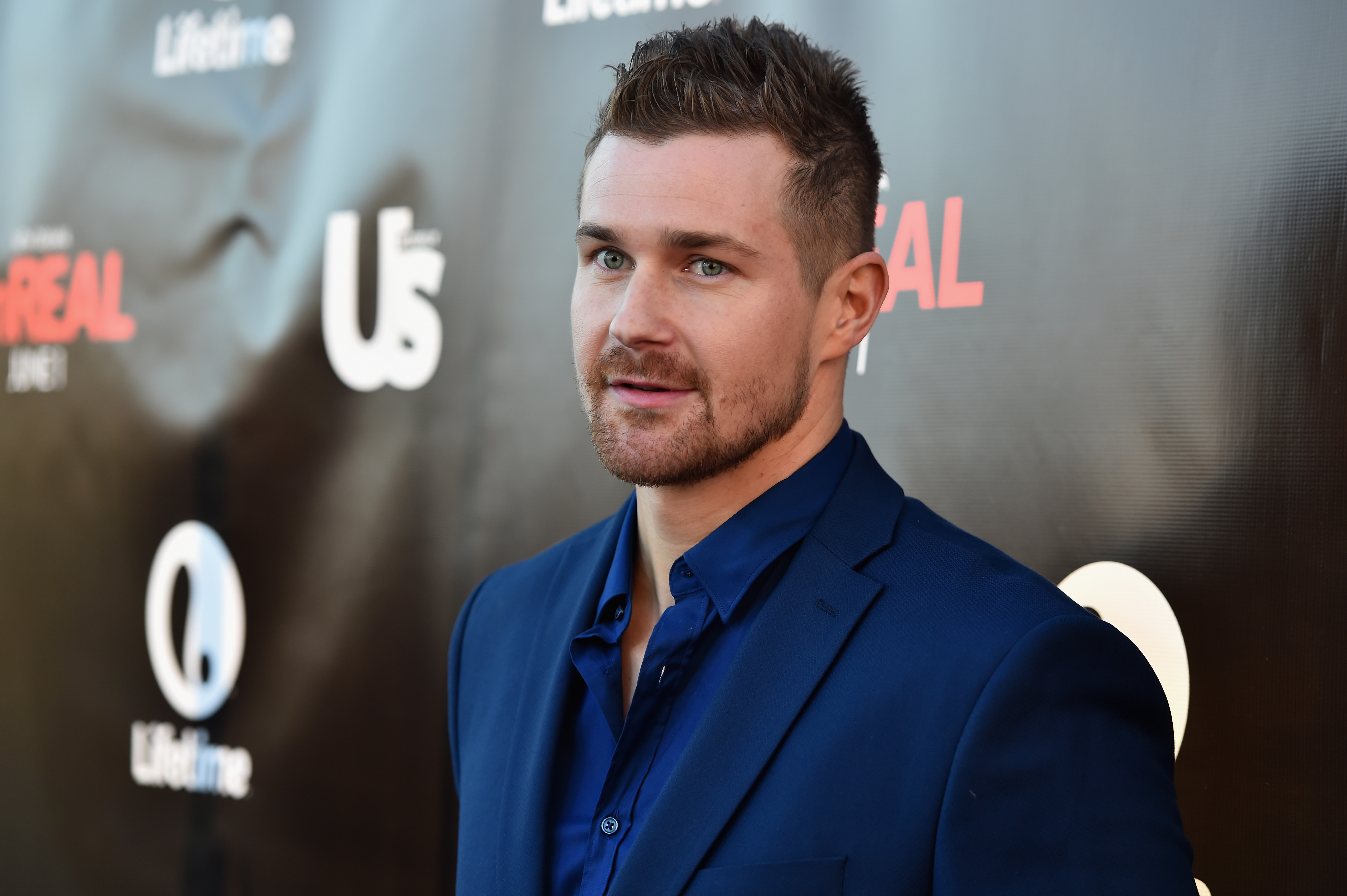 'General Hospital' actor Josh Kelly wearing a blue suit during a red carpet appearance.