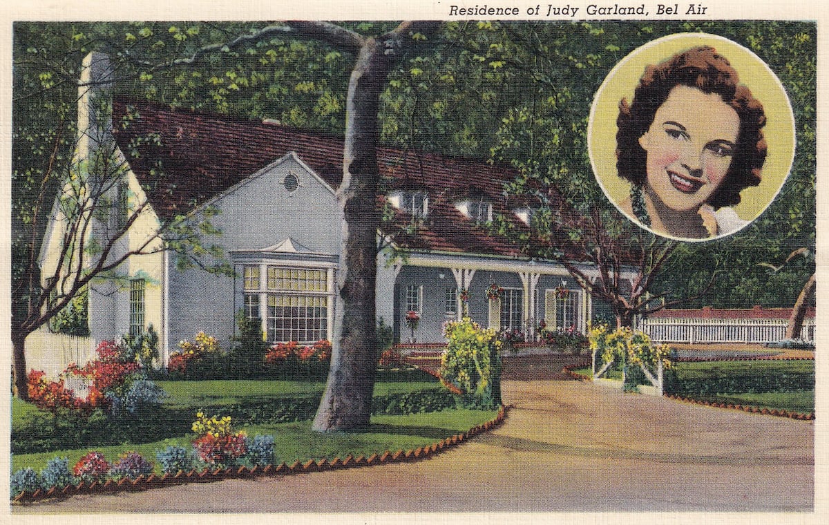 Judy Garland's Bel Air home is pictured in this vintage postcard, with a small photo of Judy Garland in the upper right corner