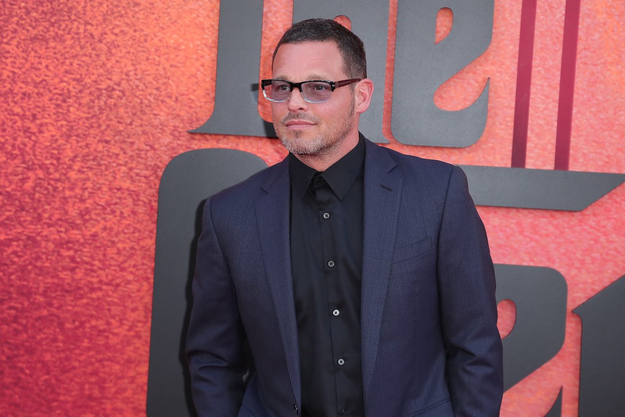 Justin Chambers poses on the red carpet in a black suit for 'The Offer' premiere.