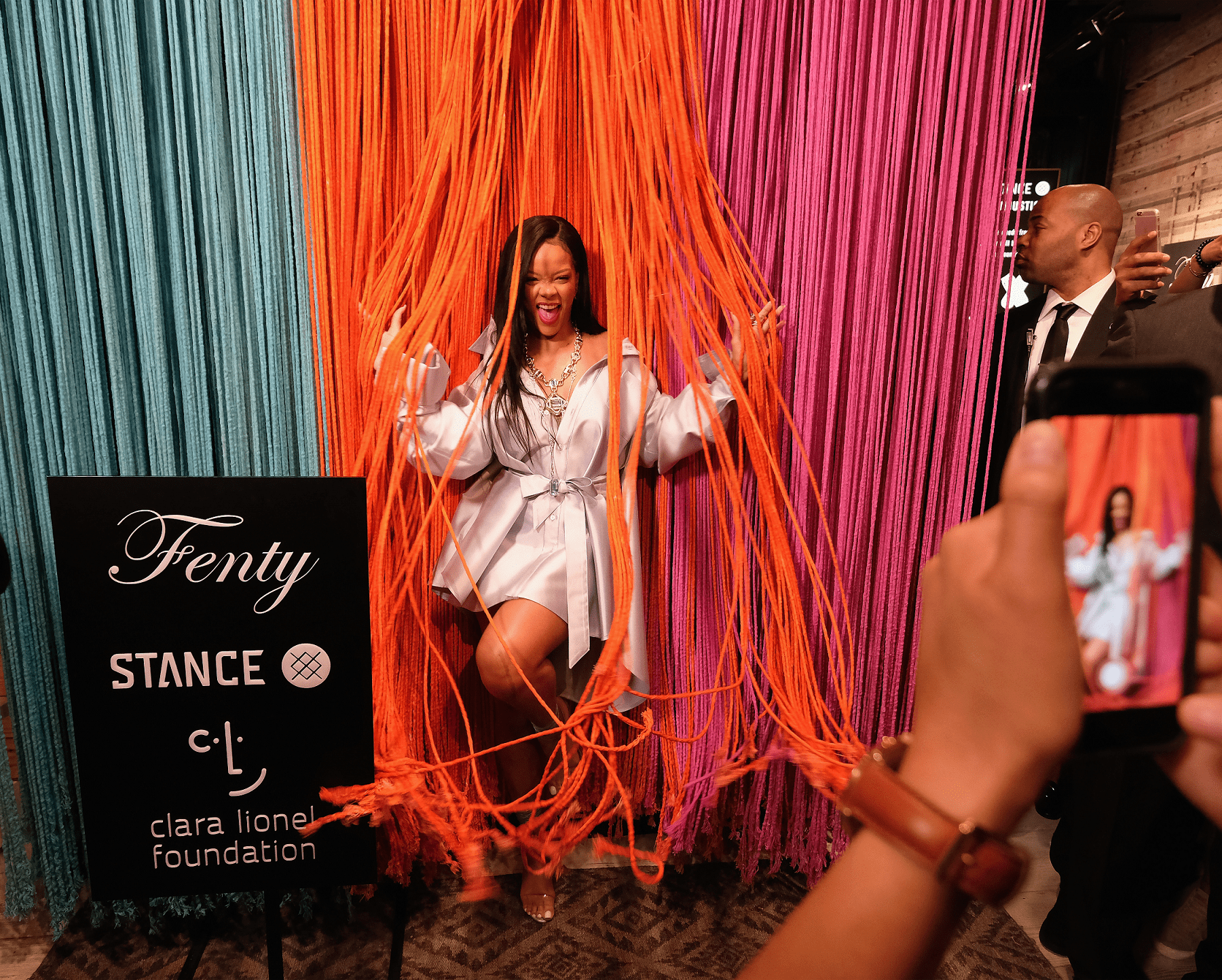 An animated Rihanna poses against a colorful backdrop at an event in 2018