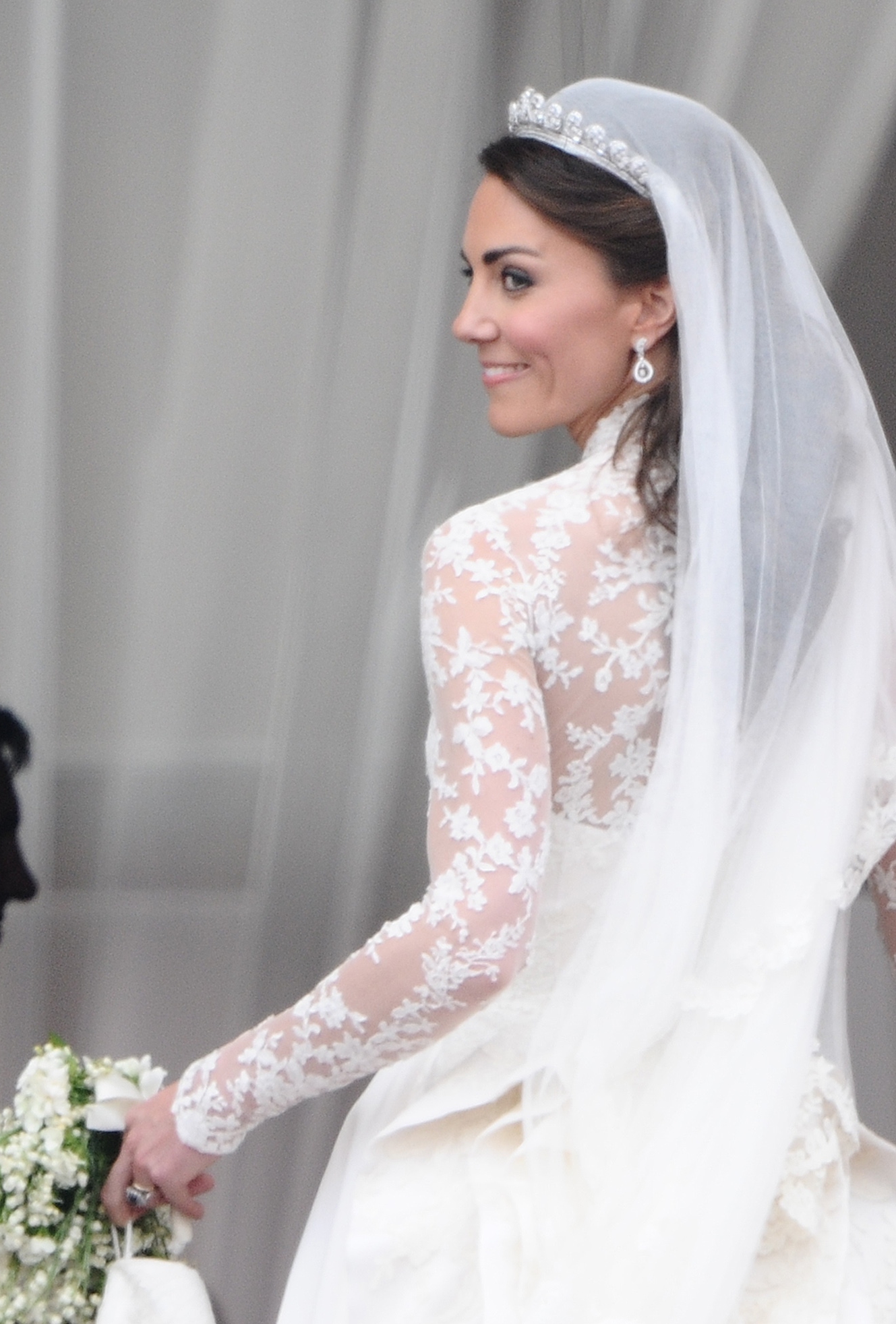 Kate Middleton turns and smiles as she leaves the balcony on her wedding day