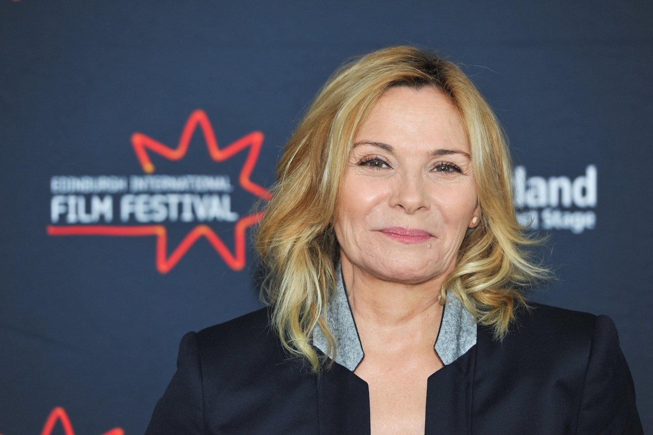 Kim Cattrall smiles on a red carpet.