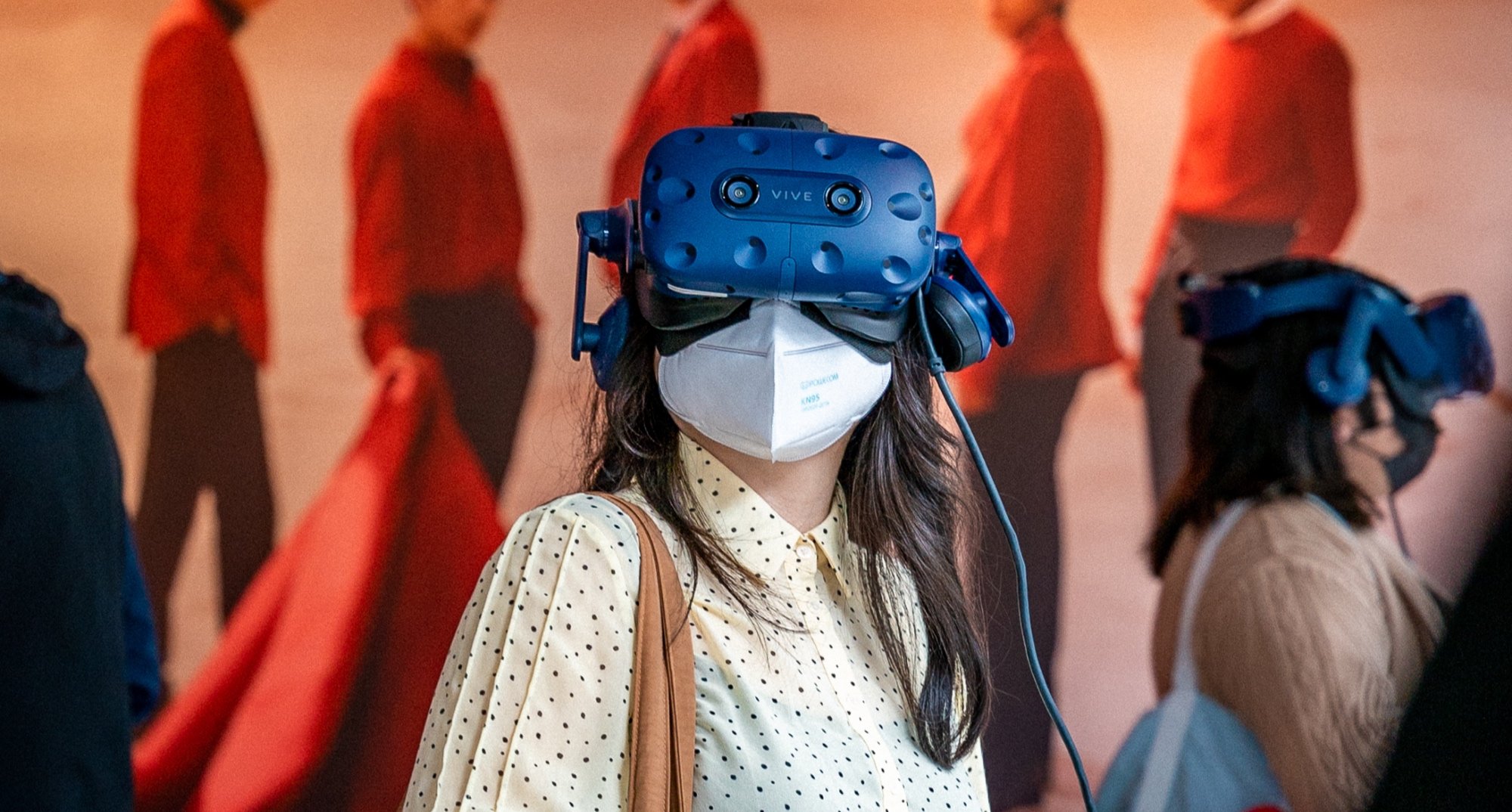 'Korea: Cubically Imagined' exhibit with visitor wearing head gear.