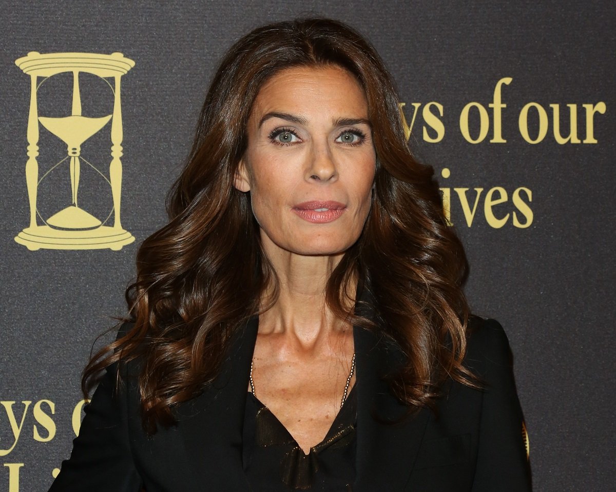 'Days of Our Lives' star Kristian Alfonso wearing a black blouse and jacket.