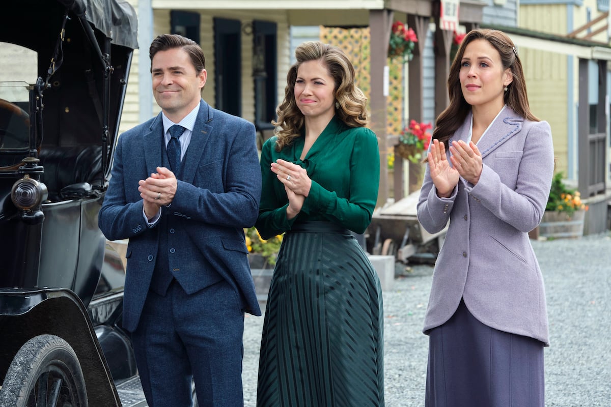 Lee (Kavan Smith), Rosemary (Pascale Hutton), and Elizabeth (Erin Krakow) clapping in the 'When Calls the Heart' Season 9 finale