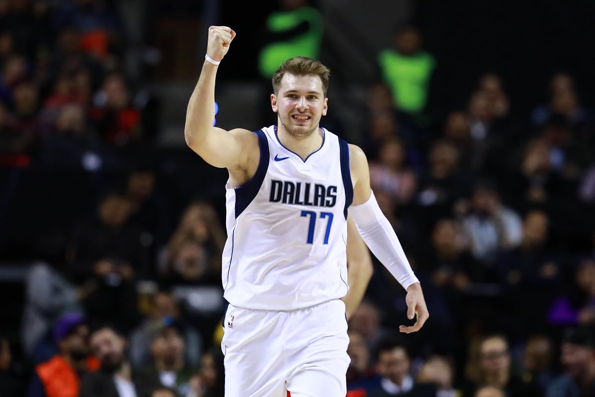 Luka Doncic, who's girlfriend is Anamaria Goltes, celebrating with his arm in the air after a Dallas Mavericks victory