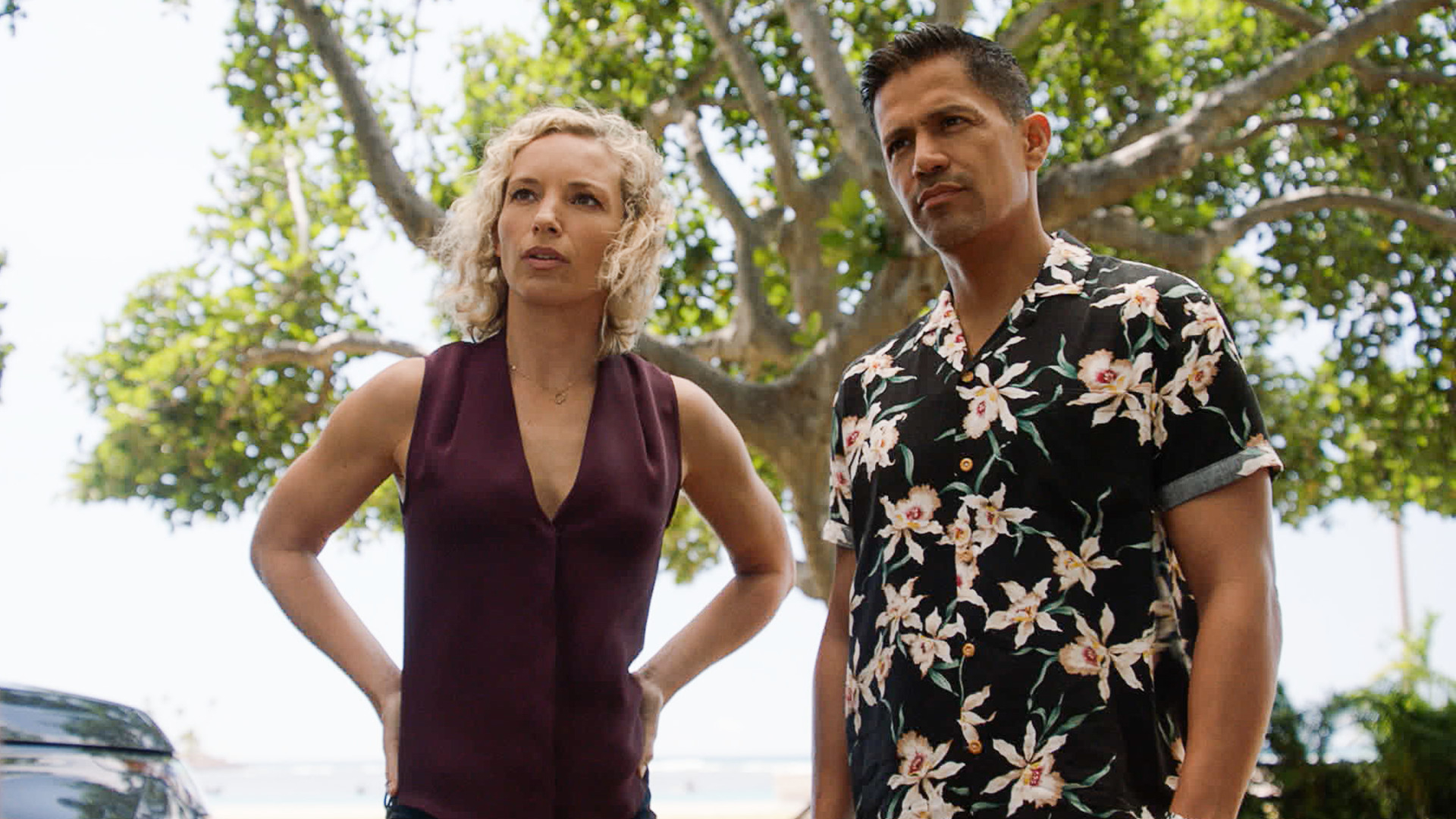 Perdita Weeks as Higgins, with her hands on her hips, standing next to Jay Hernandez an Magnum in the 'Magnum P.I.' Season 4 finale