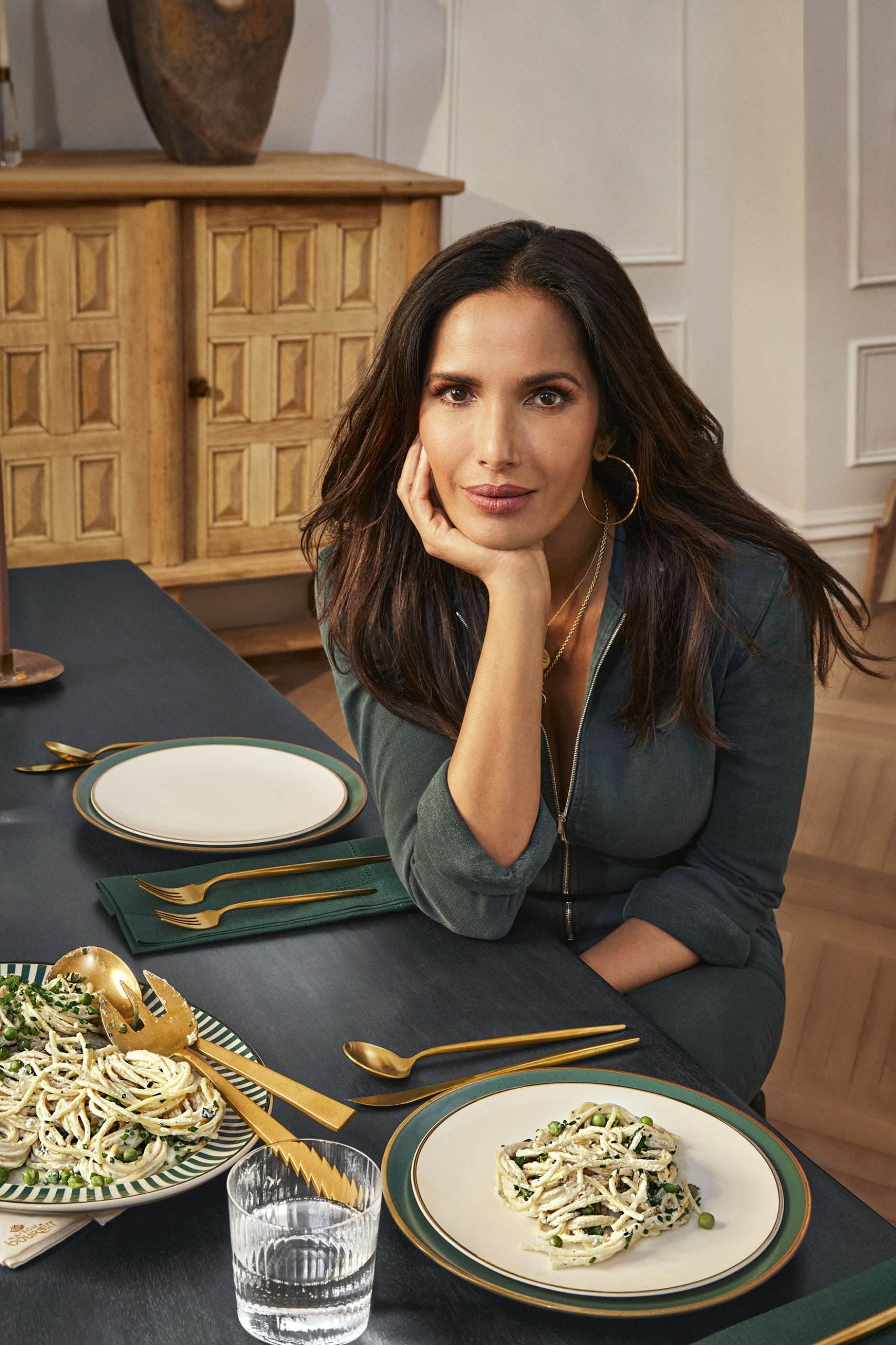 Padma Lakshmi sits at the table along with a dish of her 'Padma's Boursin e Pepe'