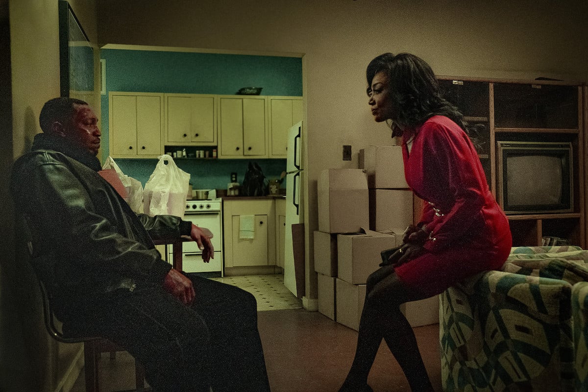Malcolm Mays as Lou Lou wearing a hospital gown and Patina Miller as Raq wearing a red suit in 'Power Book III: Raising Kanan'