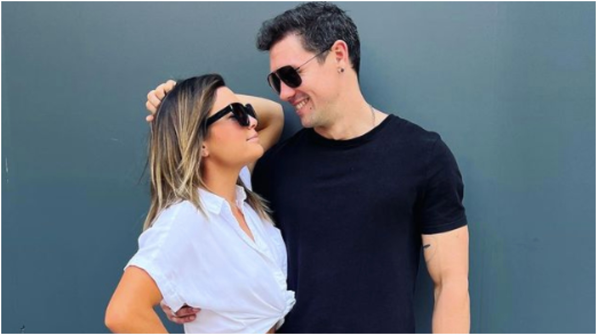 Malia White from Below Deck Med and Jake Baker smile at one another while wearing sunglasses.  
