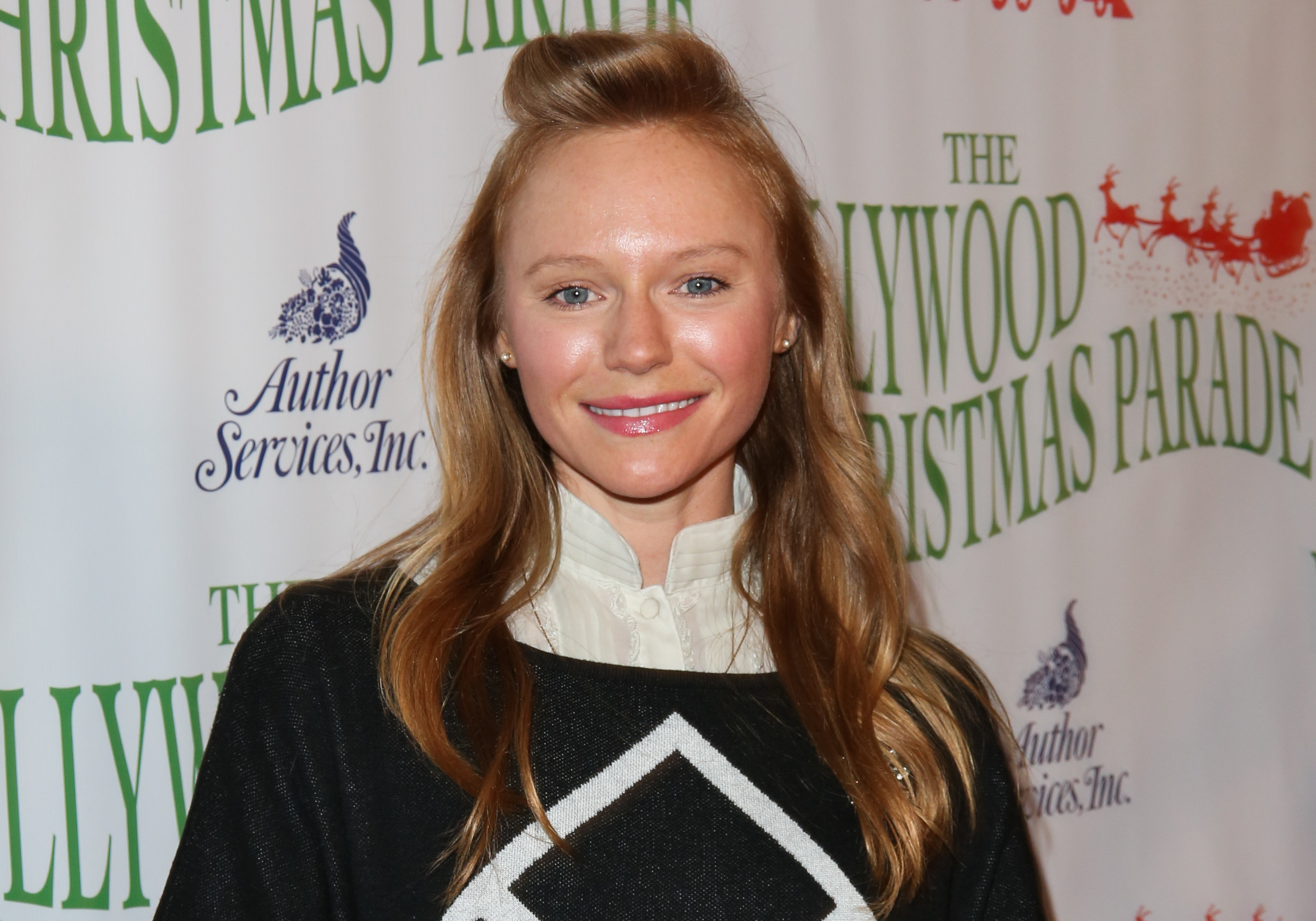 'Days of Our Lives' actor Marci Miller wearing a black and white sweater.