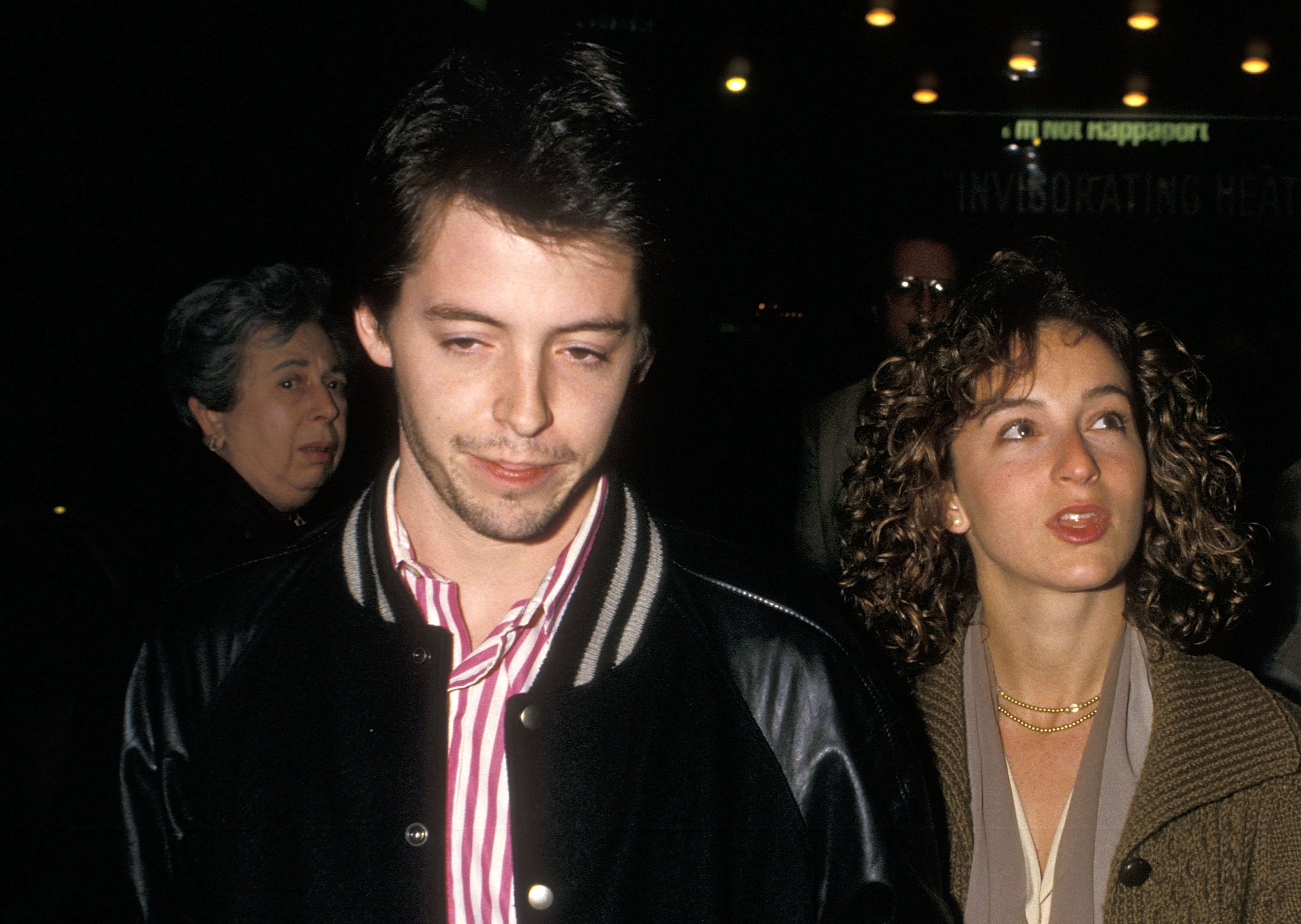 Matthew Broderick and Jennifer Grey walk together.