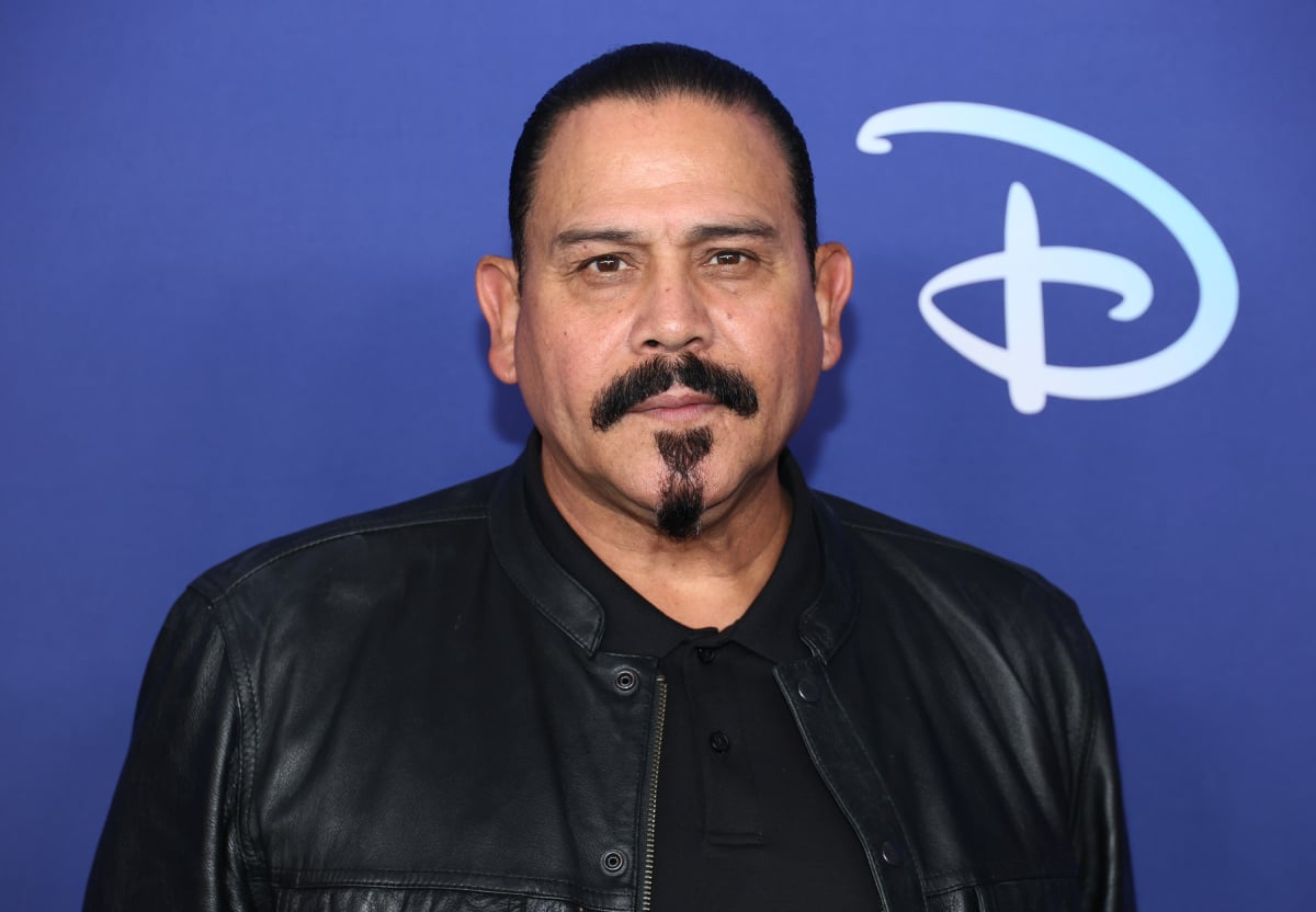 Emilio Rivera from Mayans MC attends the 2022 ABC Disney Upfront at Basketball City wearing a black shirt and black leather jacket. 