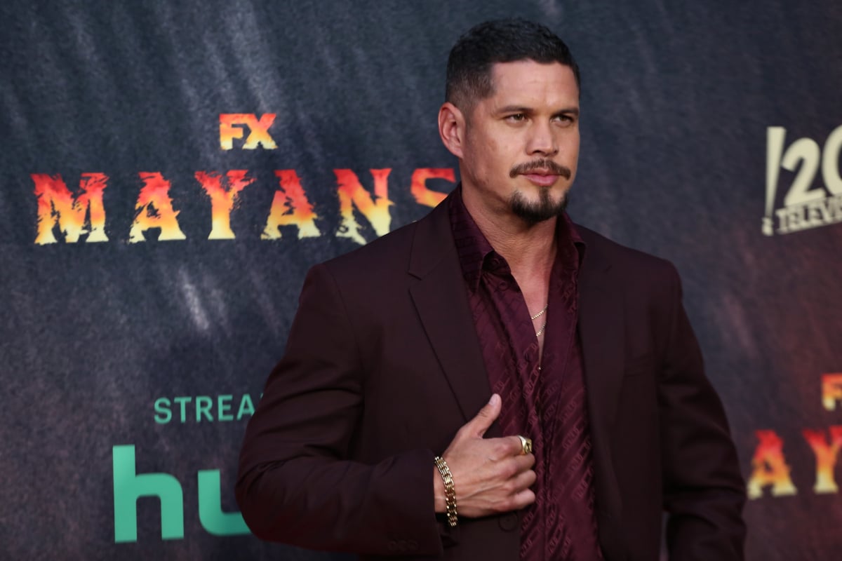 Mayans MC actor JD Pardo wears a maroon shirt and suit jacket. 