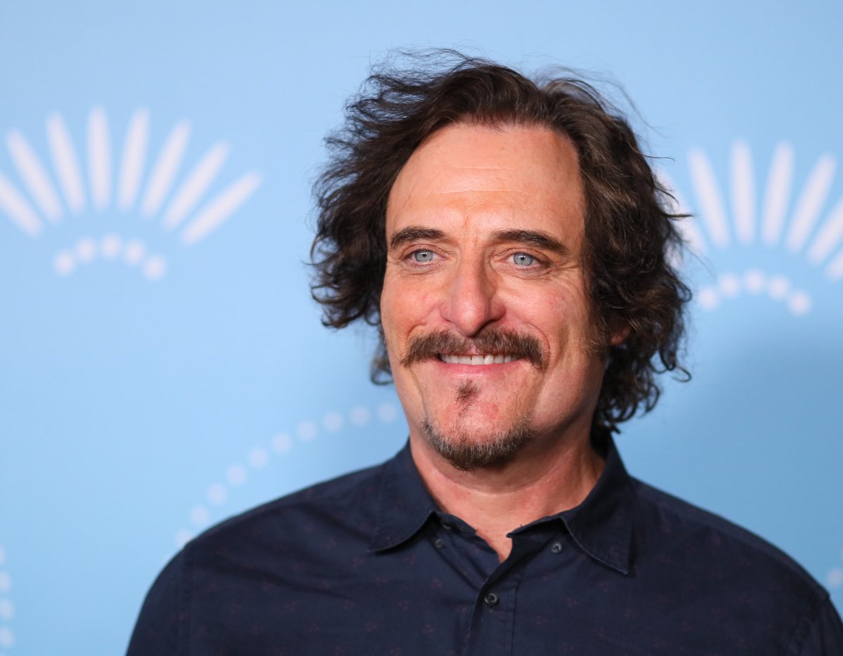 Kim Coates will return as Tig in Mayans MC Season 4. Coates wheres a button-up shirt. 