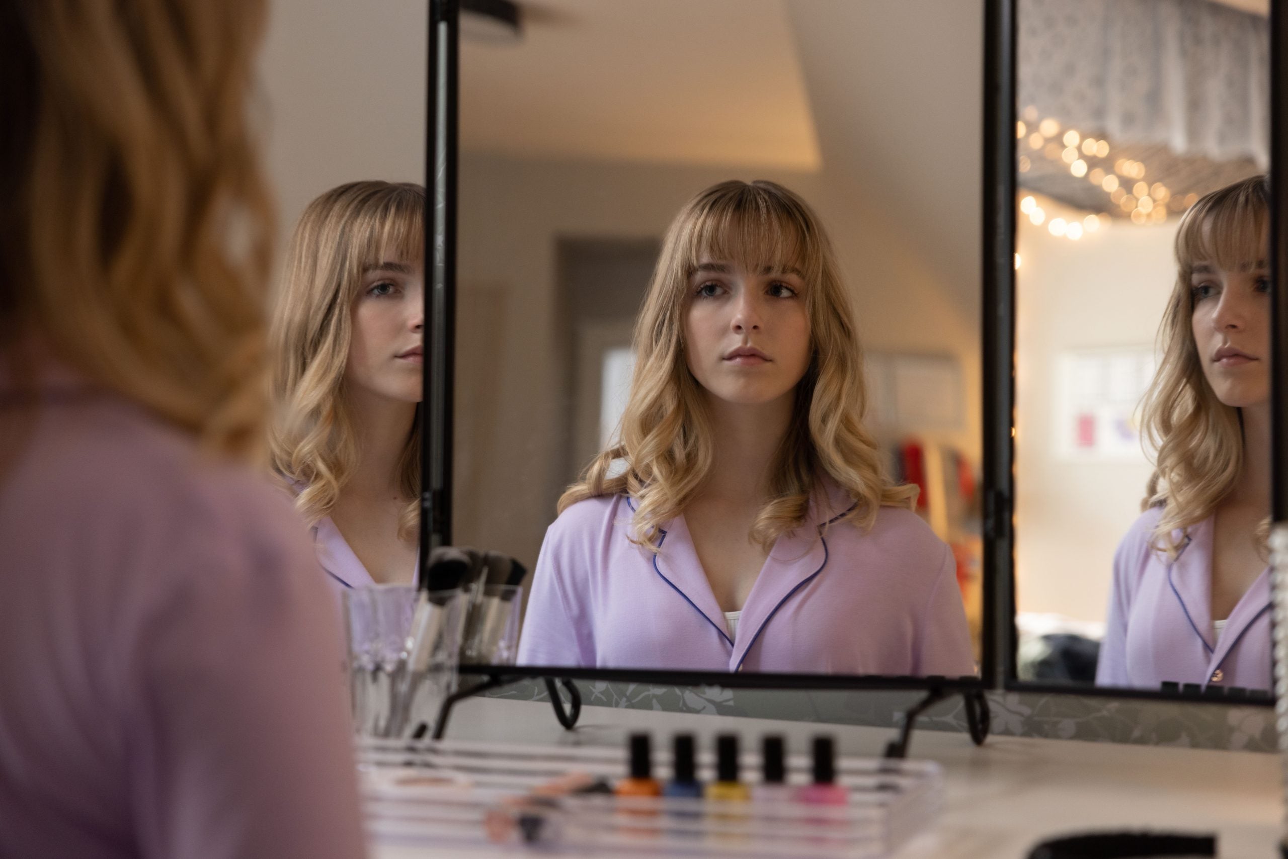 McKenna Grace as Emma, looking in a mirror, in the Lifetime movie 'The Bad Seed Returns'