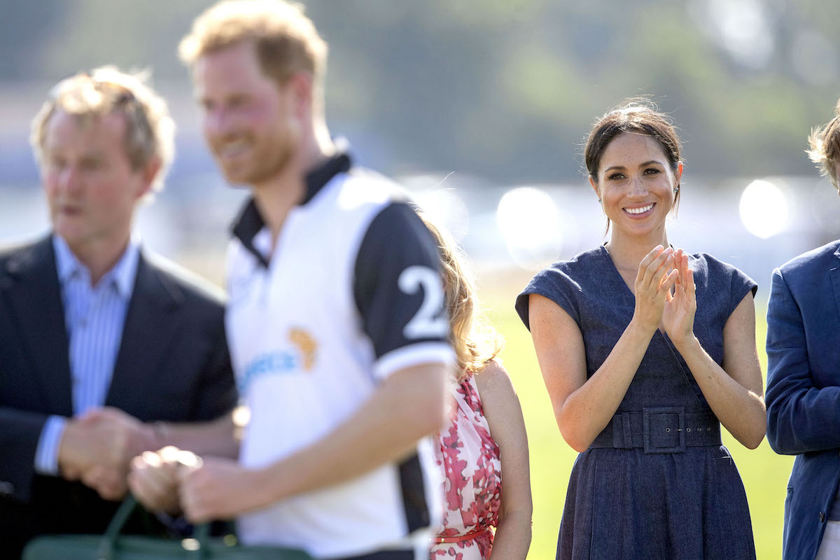 Meghan Markle claps as she watches Prince Harry play polo