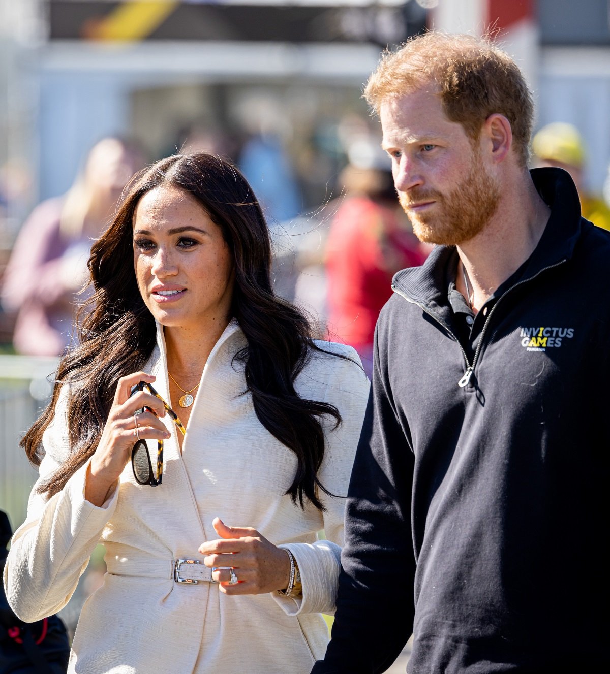 Meghan Markle and Prince Harry, who a royal expert believe have a money problem now, looking on at day two of the Invictus Games