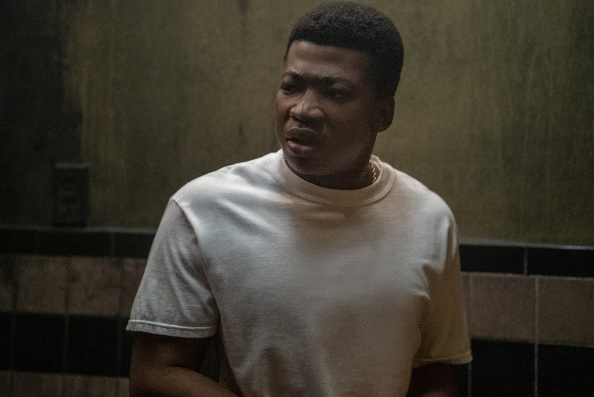 Mekai Curtis as Kanan Stark wearing a white t-shirt and a frown in 'Power Book III: Raising Kanan'