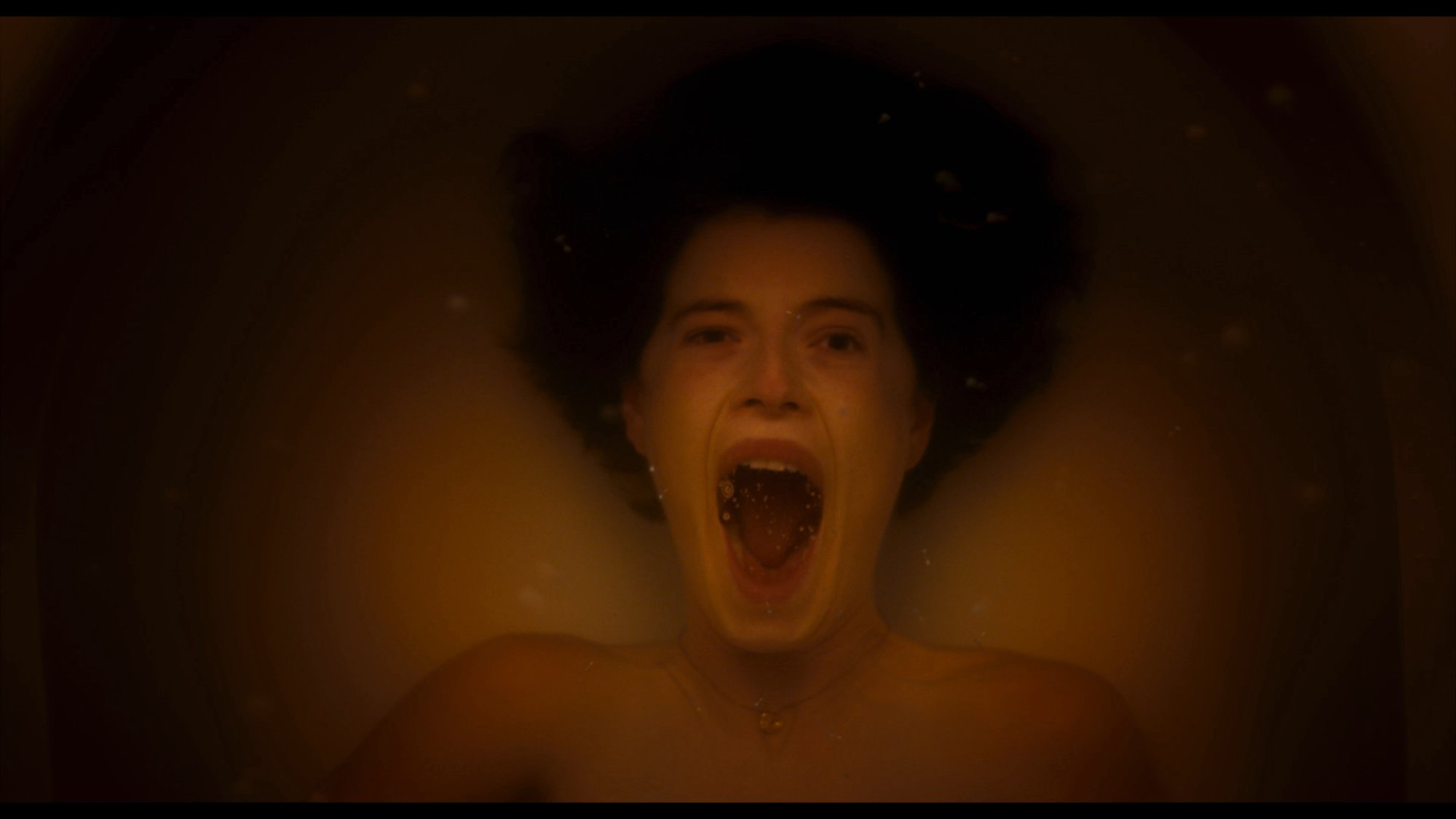 'Men' Jessie Buckley as Harper screaming underneath the water in a bathtub
