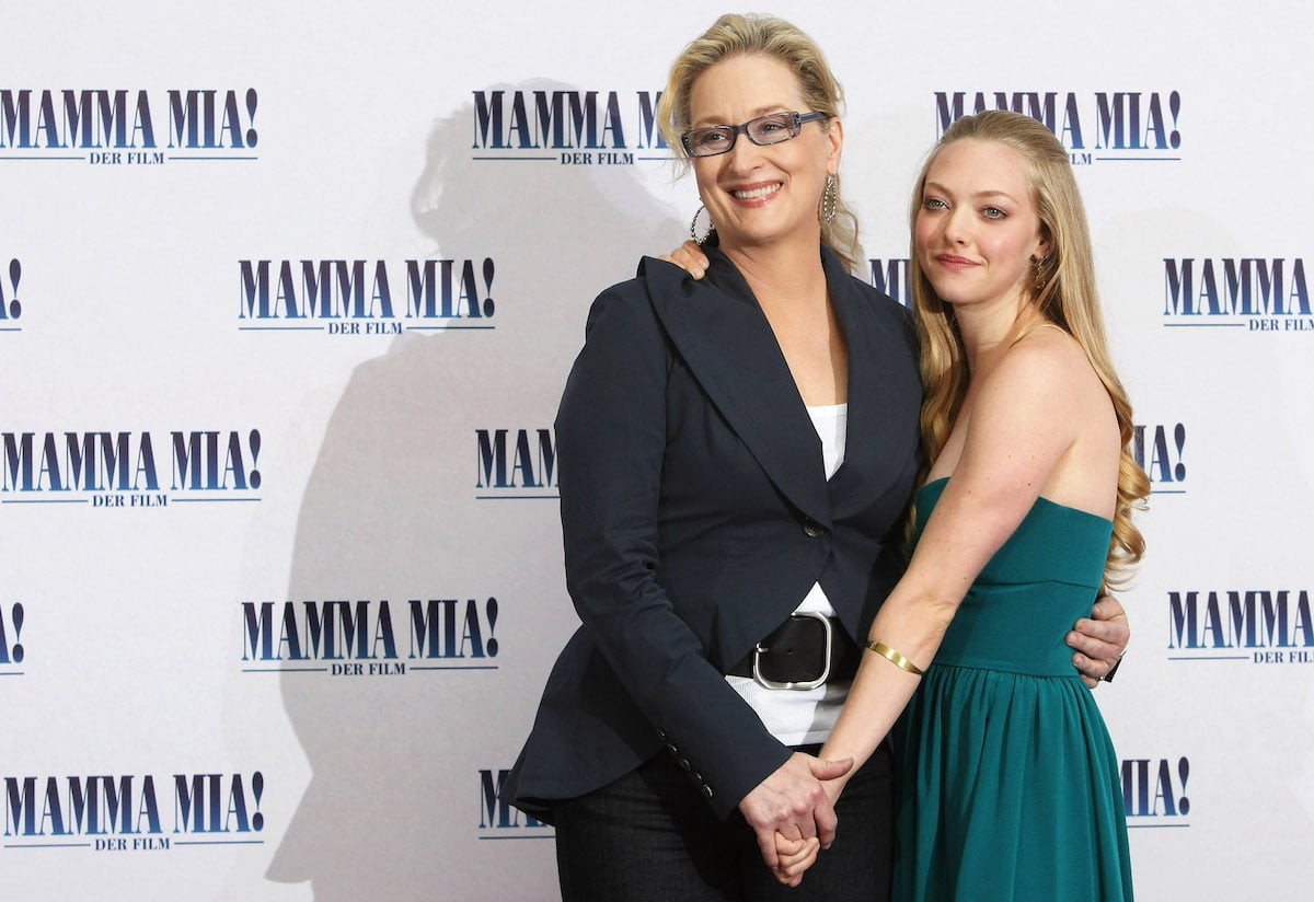 Actresses Meryl Streep and Amanda Seyfried hold hands at the premiere for "Mamma Mia! The Movie" in 2008