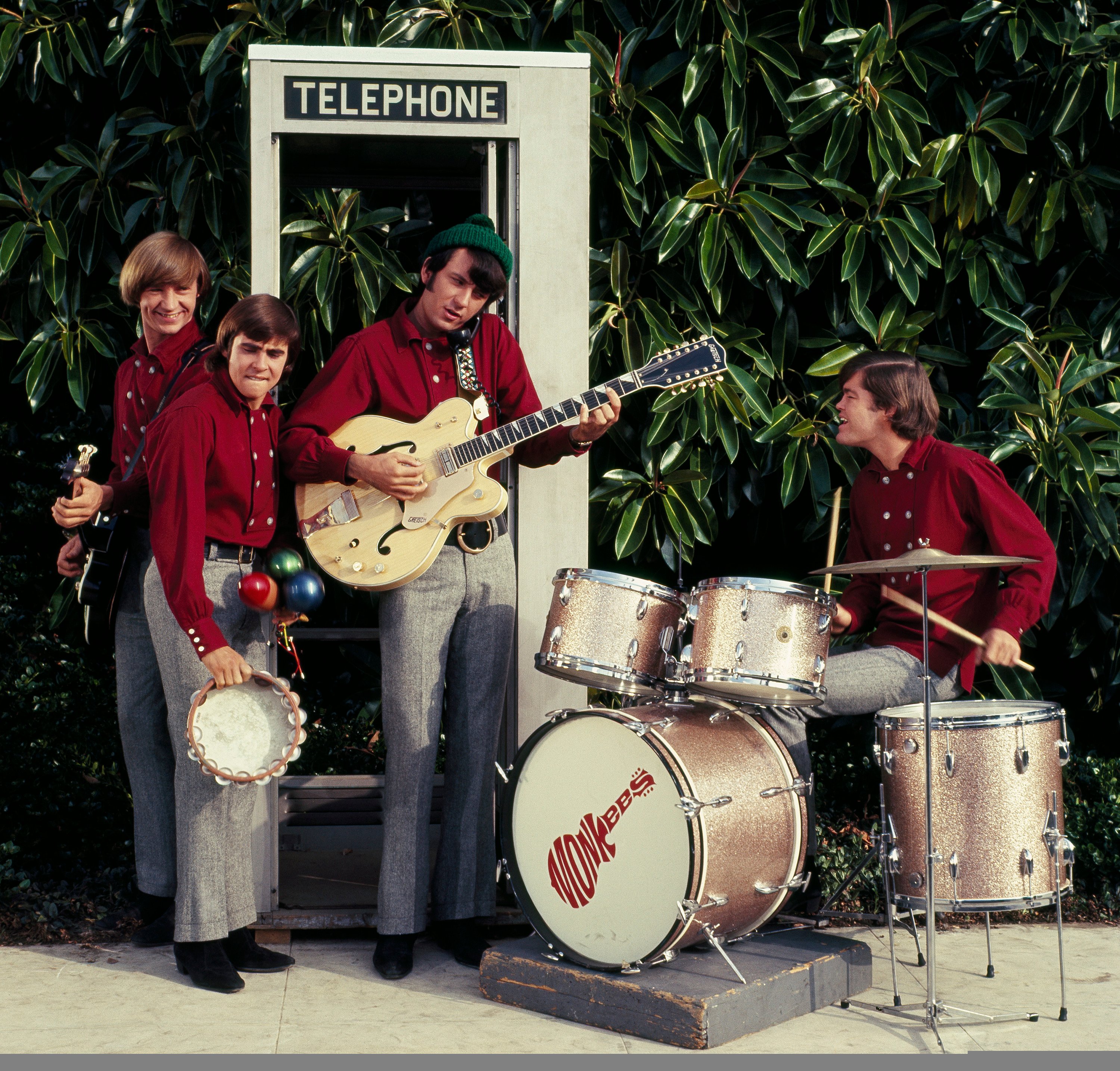 The Monkees' Peter Tork, Davy Jones, Mike Nesmith, and Micky Dolenz playing songs near plants