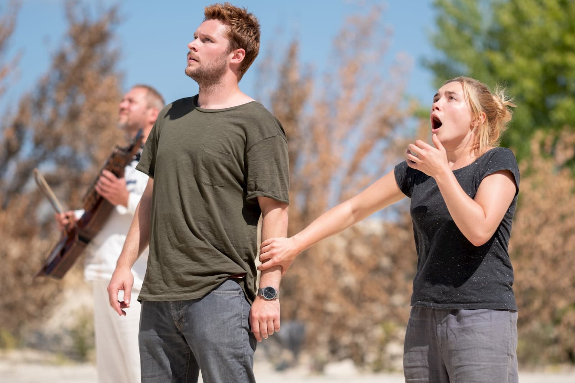'Midsommar' Jack Reynor as Christian and Florence Pugh as Dani, inspiring an A24 theme park. Pugh holding Reynor's arm looking up in shock.