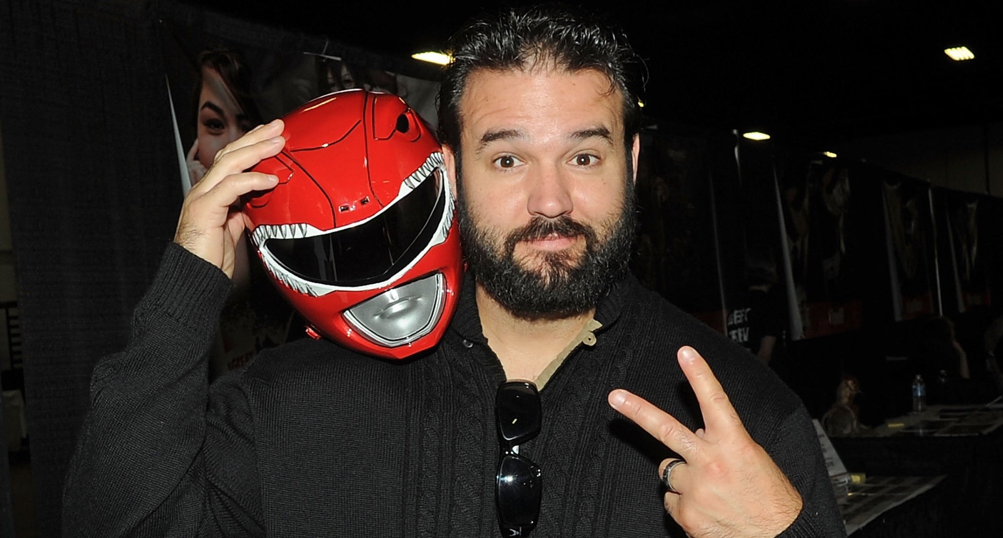 'Mighty Morphin Power Rangers' star Austin St. John holding Red Ranger helmet.