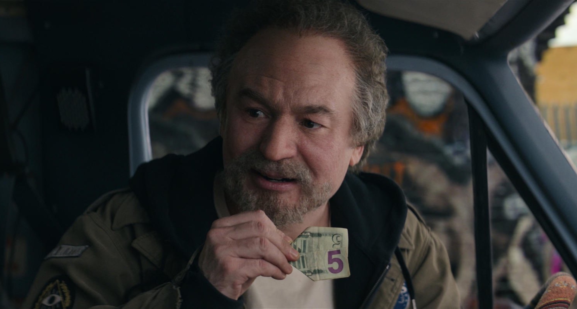 Mike Myers as Anthony in 'The Pentaverate' series holding a five dollar bill.