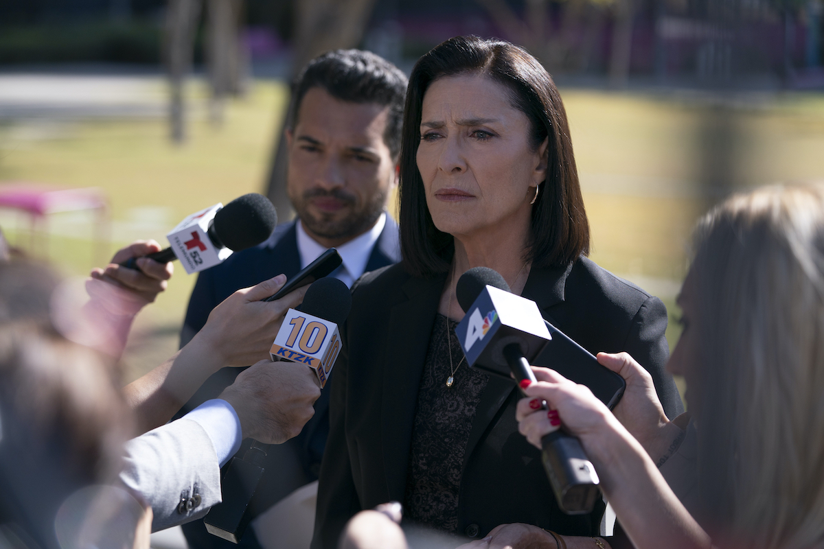Mimi Rogers as Honey Chandler standing in front of reporters' microphones in the 'Bosch: Legacy' season finale 