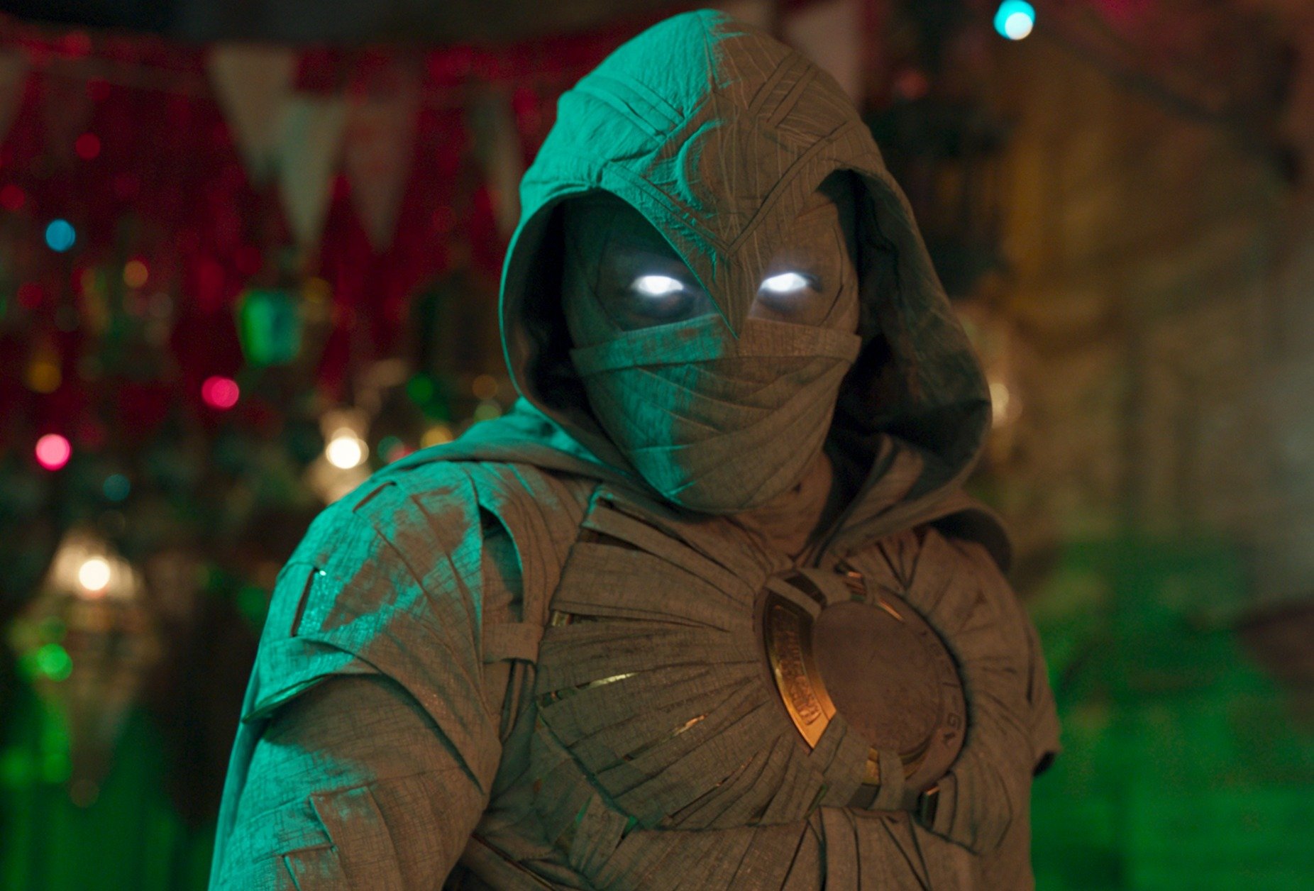 Oscar Isaac as Moon Knight in the 'Moon Knight' finale, which featured QR codes. He's wearing the grey costume, which consists of a mask and cloak. His eyes are white and glowing.