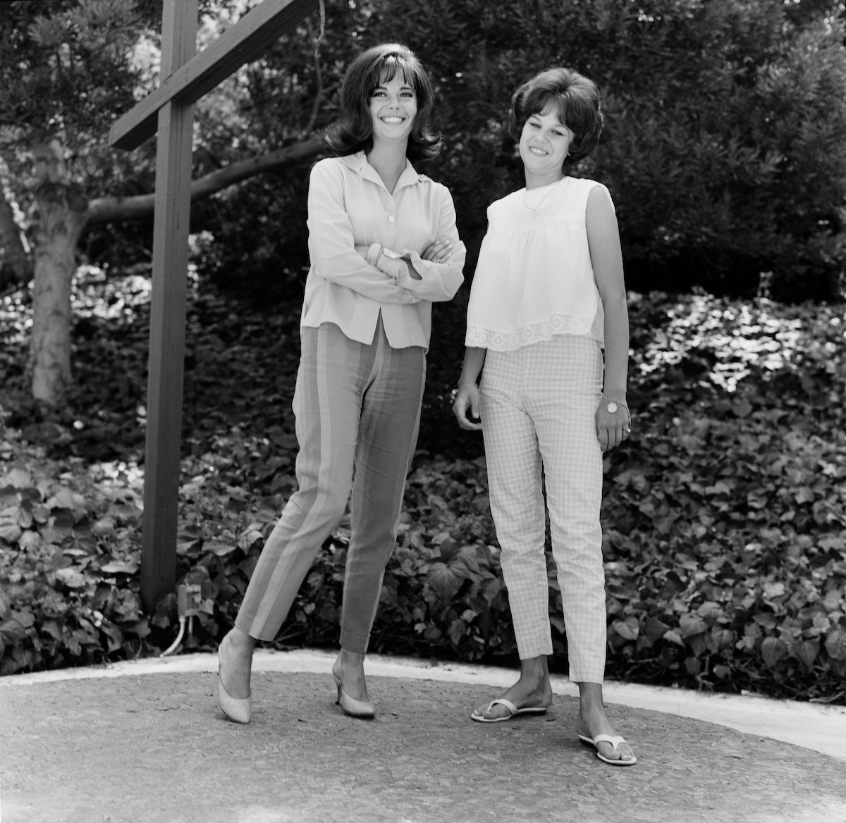 Natalie Wood and sister Lana Wood smiling, in black and white