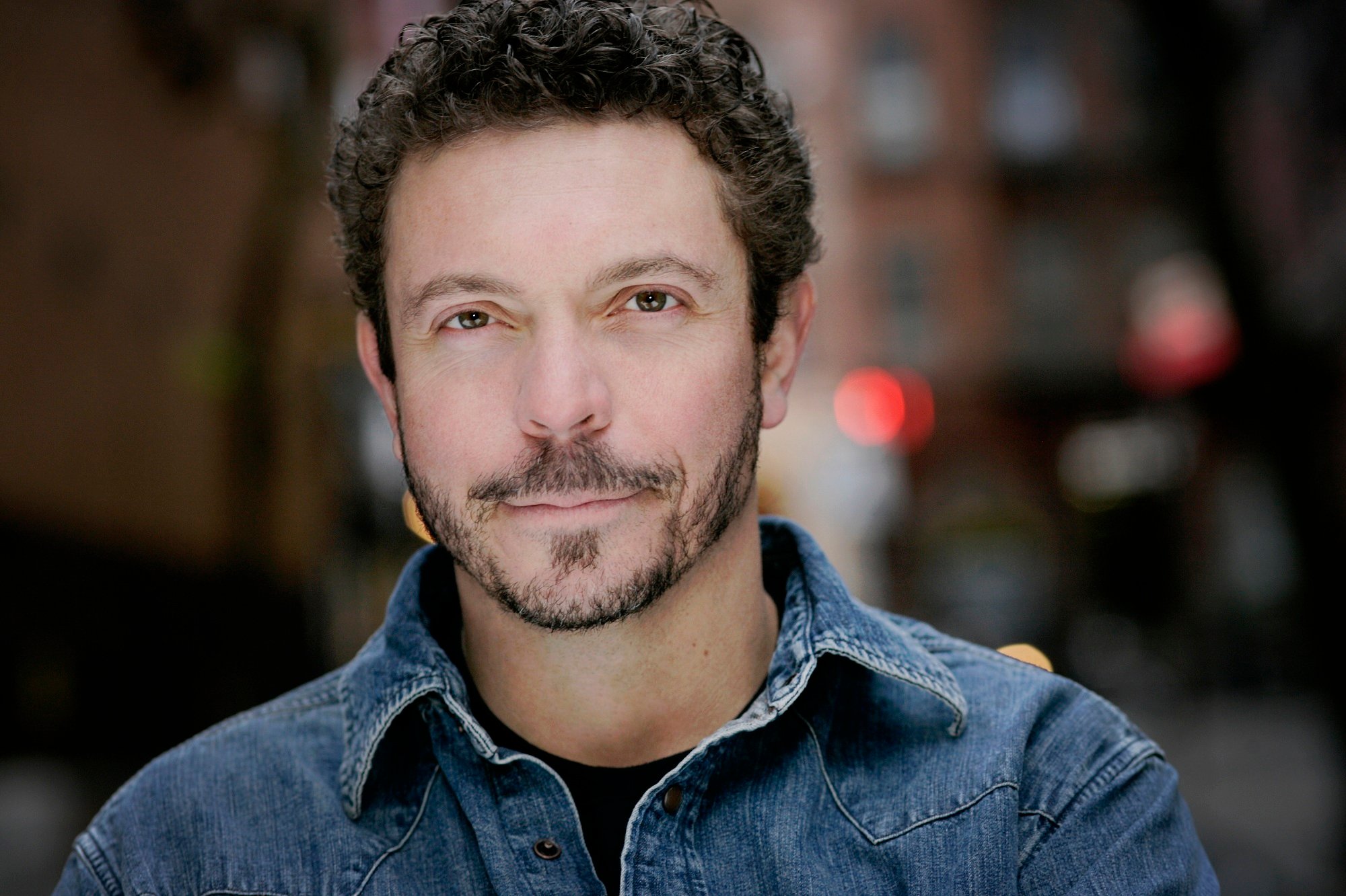 Actor Nick Basta wearing a denim shirt