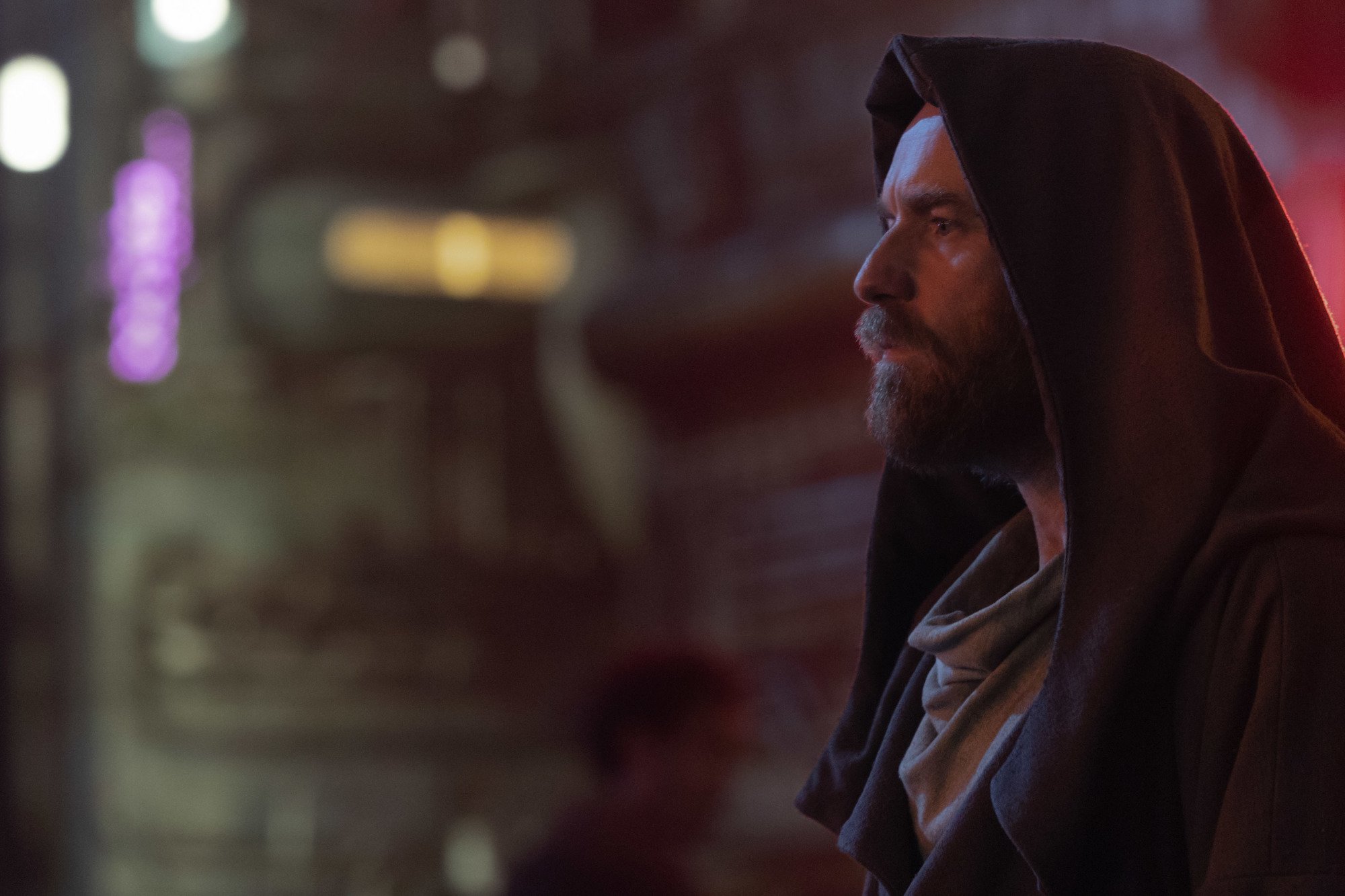 Ewan McGregor as Obi-Wan in 'Obi-Wan Kenobi.' He's wearing a hood and staring out at something off-screen.