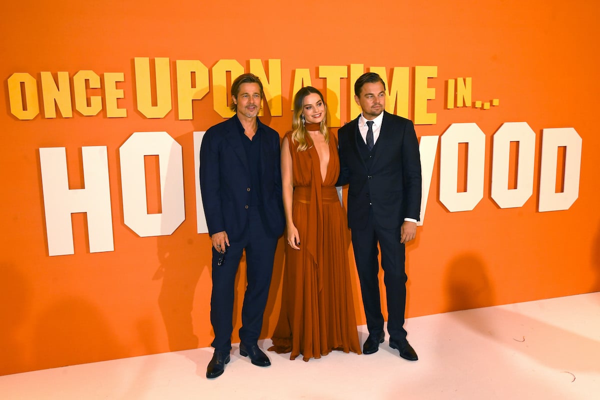 Brad Pitt, Margot Robbie and Leonardo DiCaprio smiling cast members of 